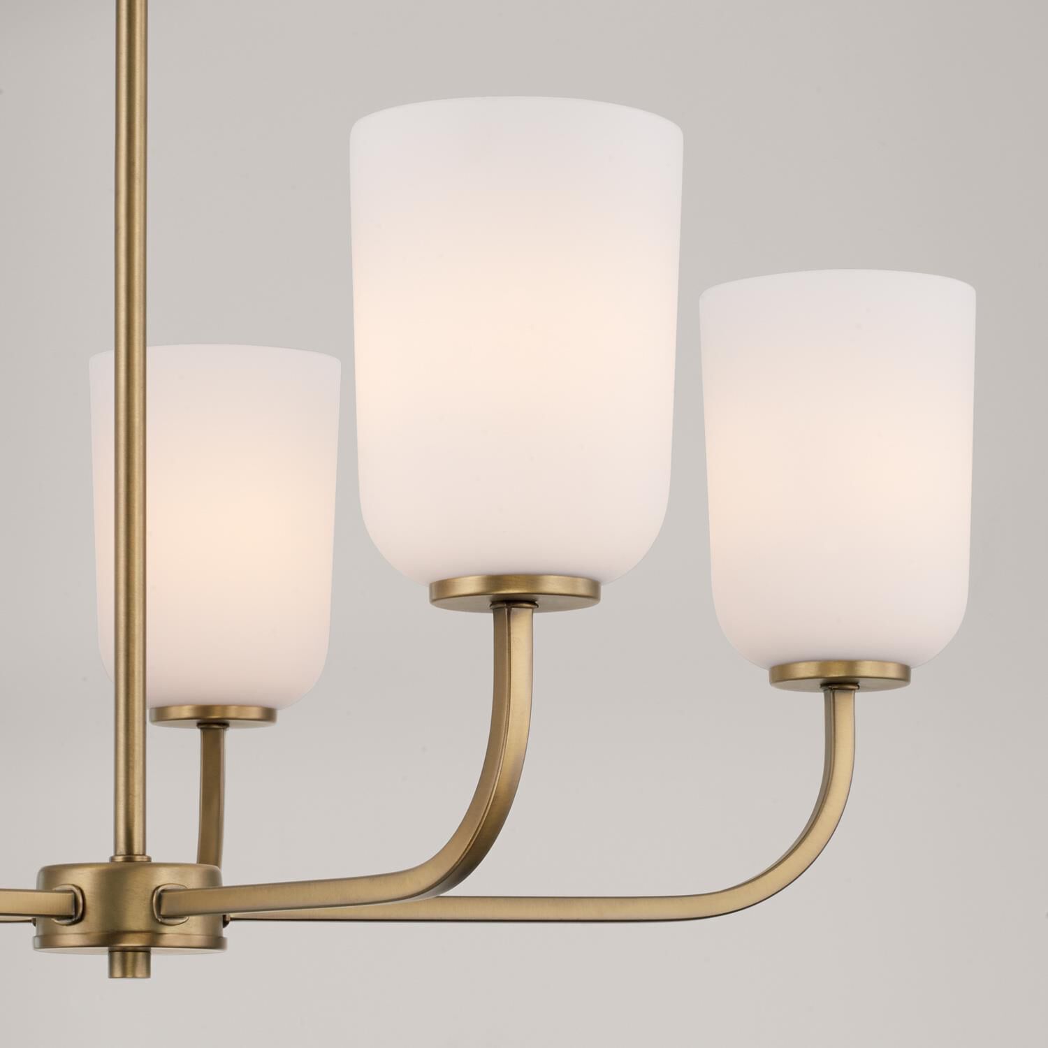 Shown in Aged Brass finish and Soft White glass