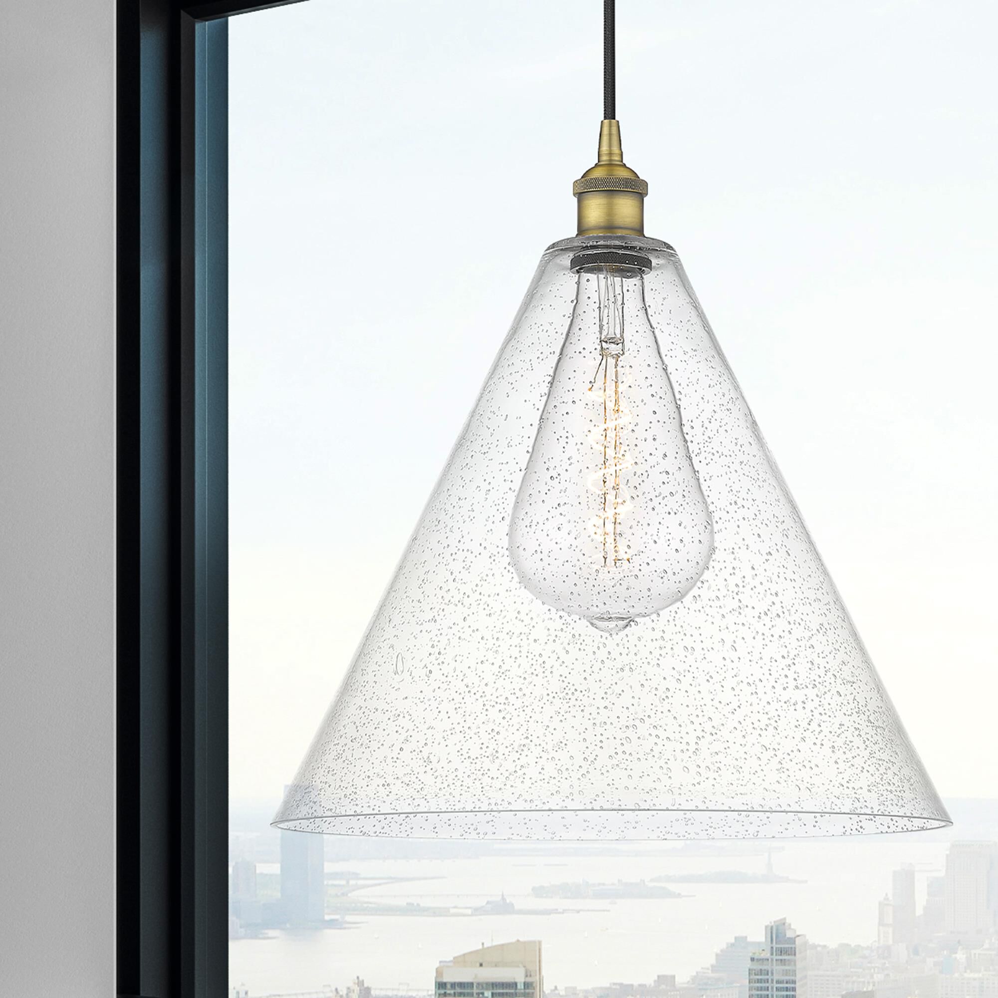 Shown in Brushed Brass finish and Seedy glass