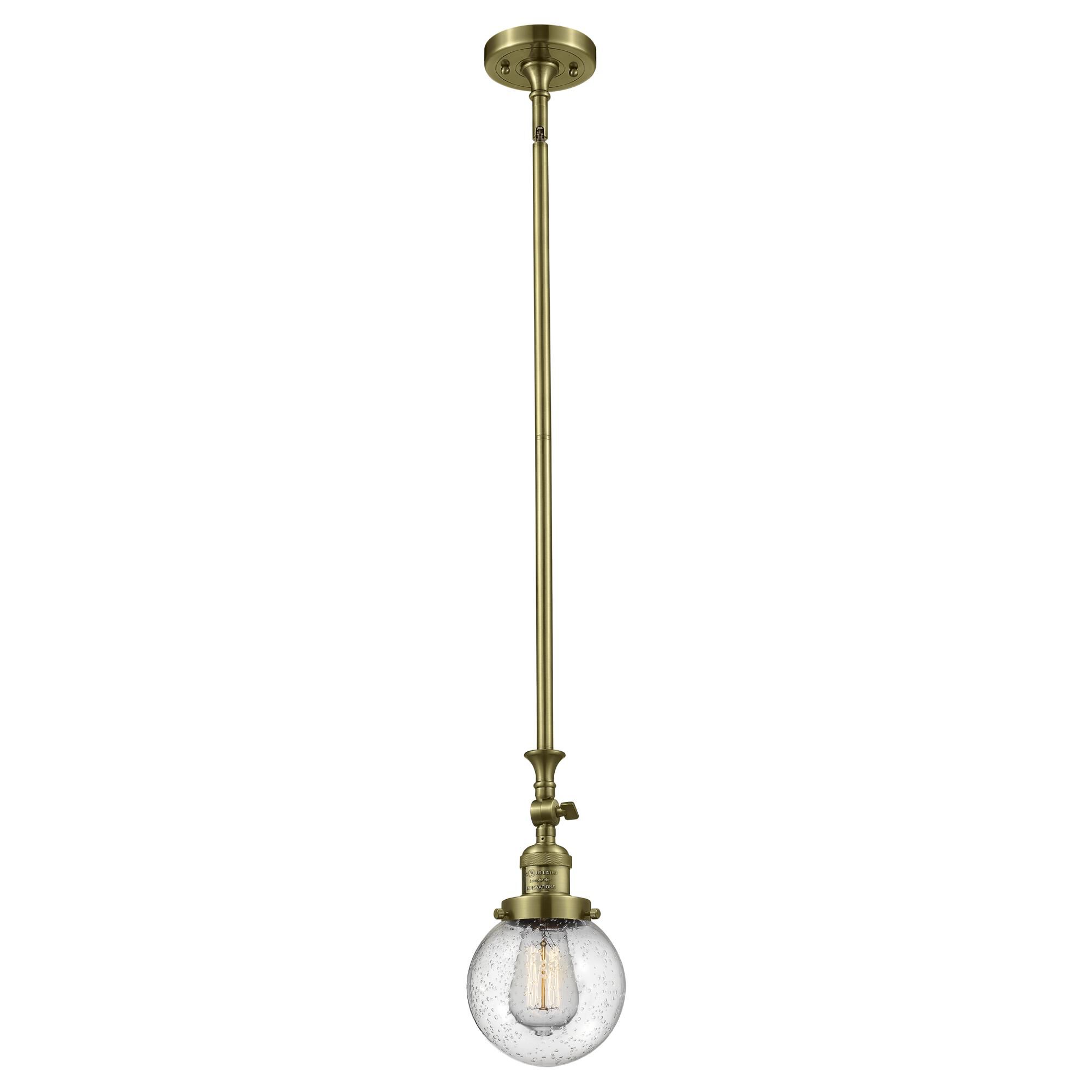 Shown in Antique Brass finish and Seedy glass