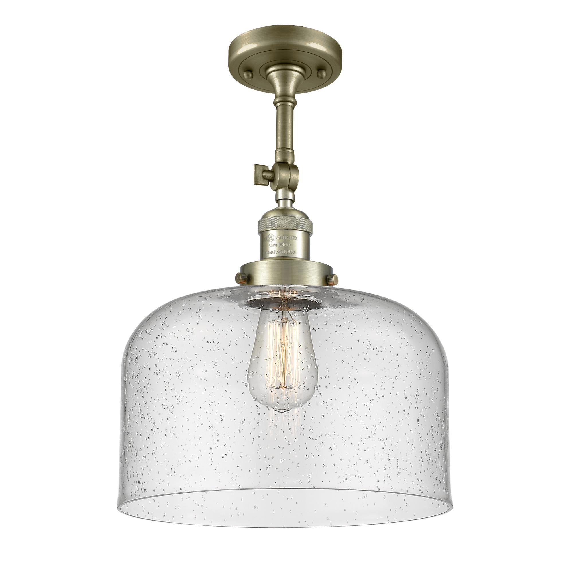 Shown in Antique Brass finish and Seedy glass