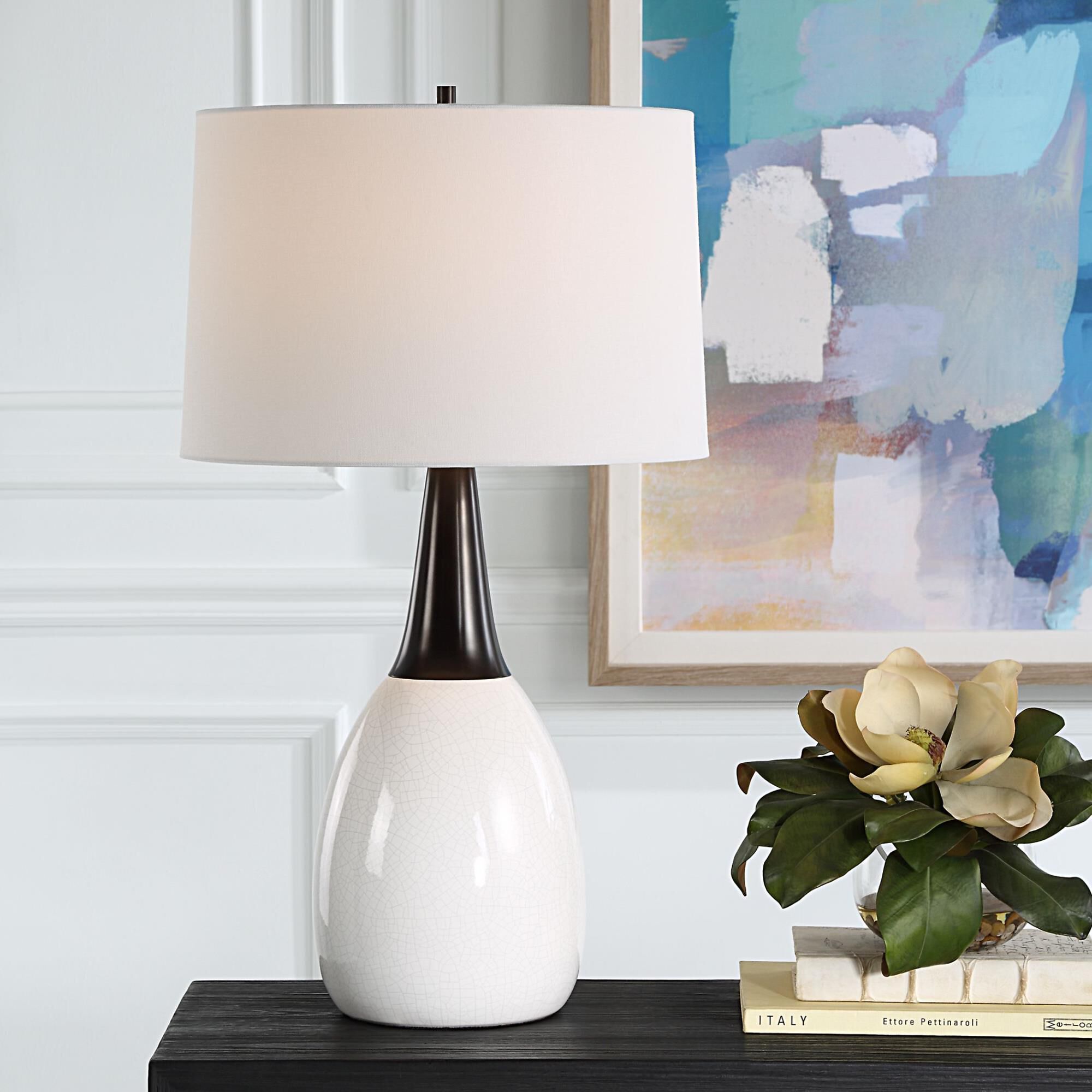 Shown in This Unique Table Lamp Seamlessly Blends Elegance And Uniqueness Into One Captivating Design. The Cr finish and Round Hardback shade