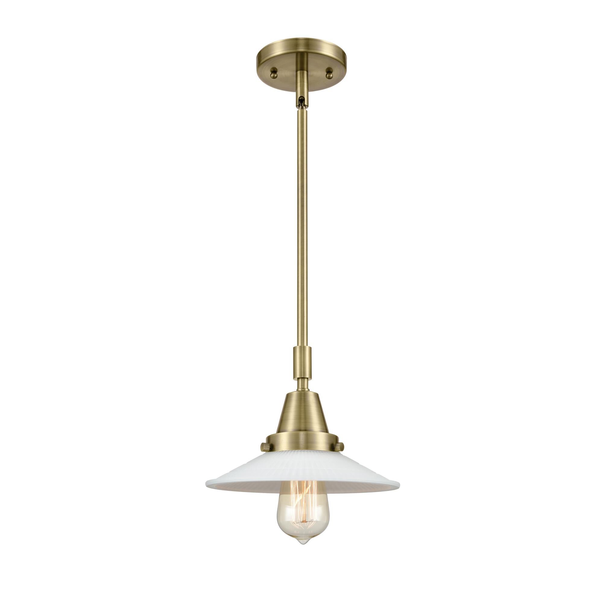 Shown in Antique Brass finish and White Halophane glass