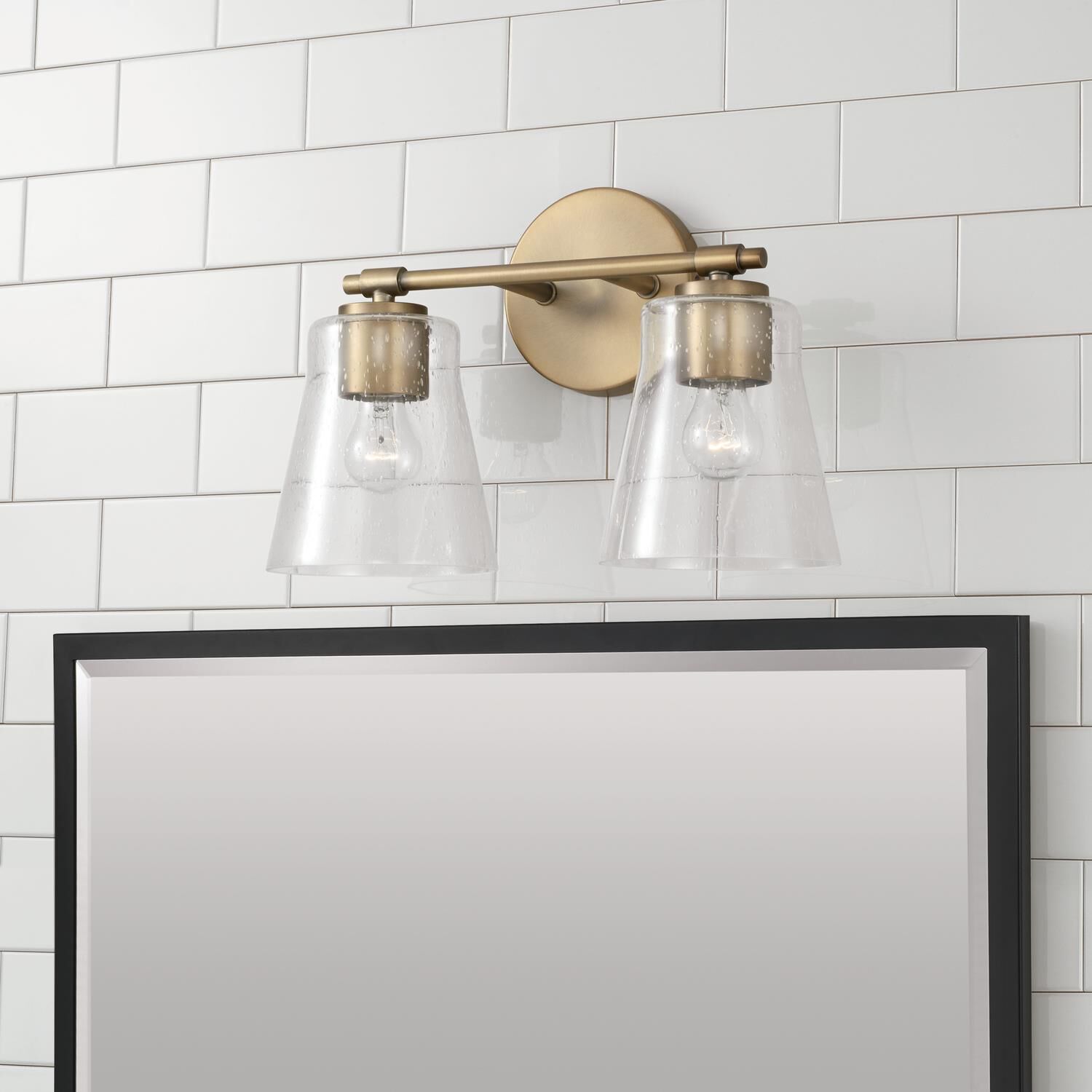 Shown in Aged Brass finish and Clear Seeded glass