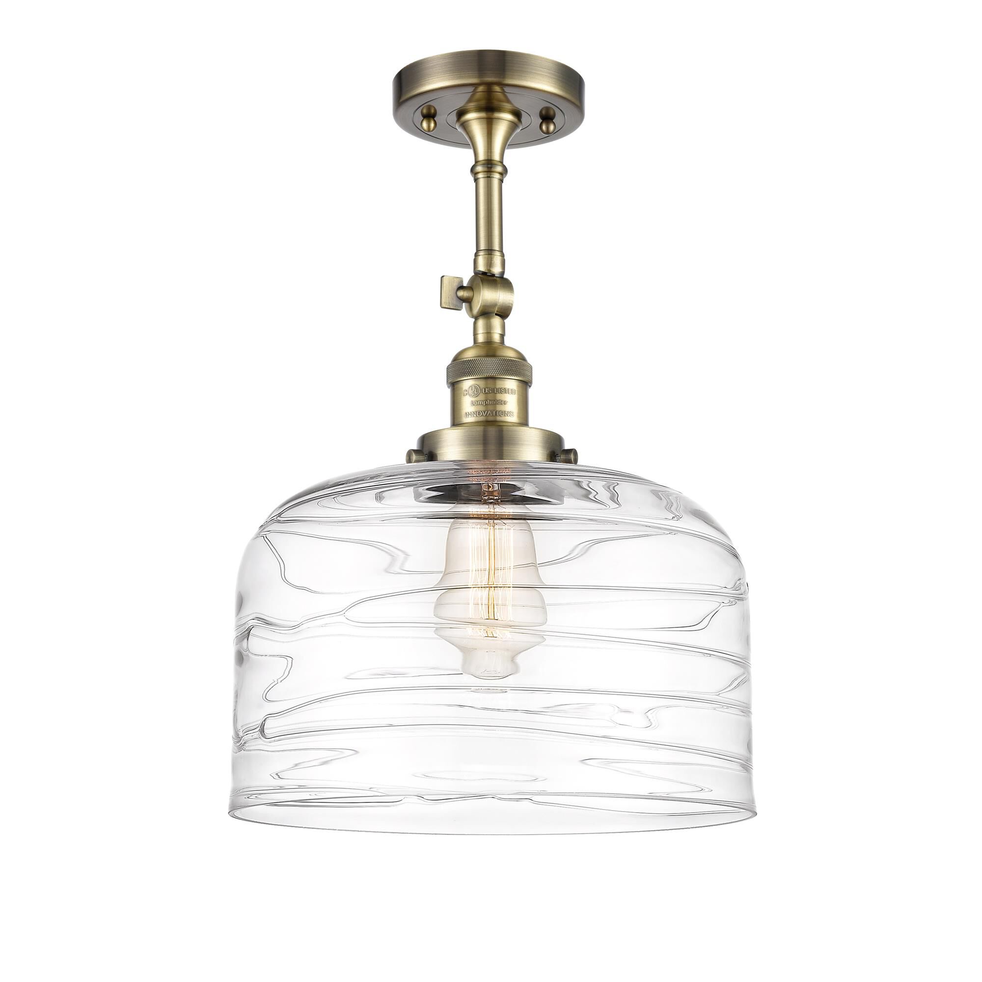 Shown in Antique Brass finish and Clear Deco Swirl X-Large Bell glass