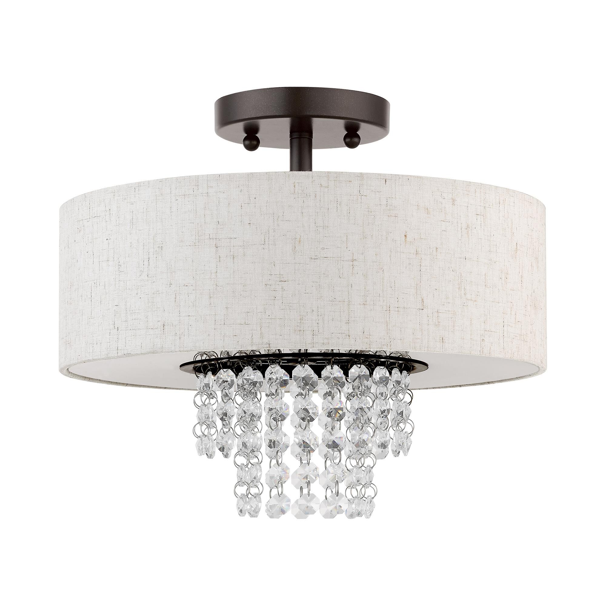 Shown in English Bronze finish and Hand Crafted Oatmeal Color Fabric Outside & White Fabric Inside Hardback  with Clear Crystals shade