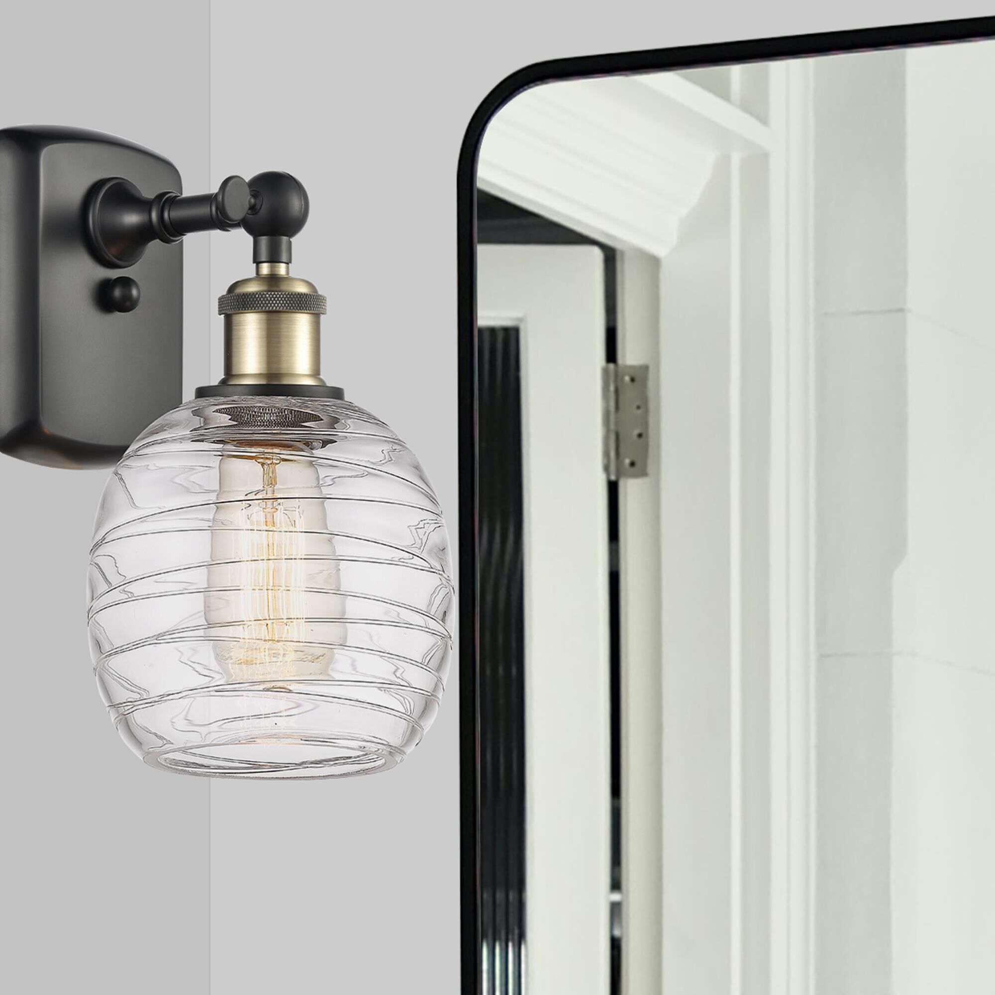 Shown in Black Antique Brass finish and Deco Swirl glass