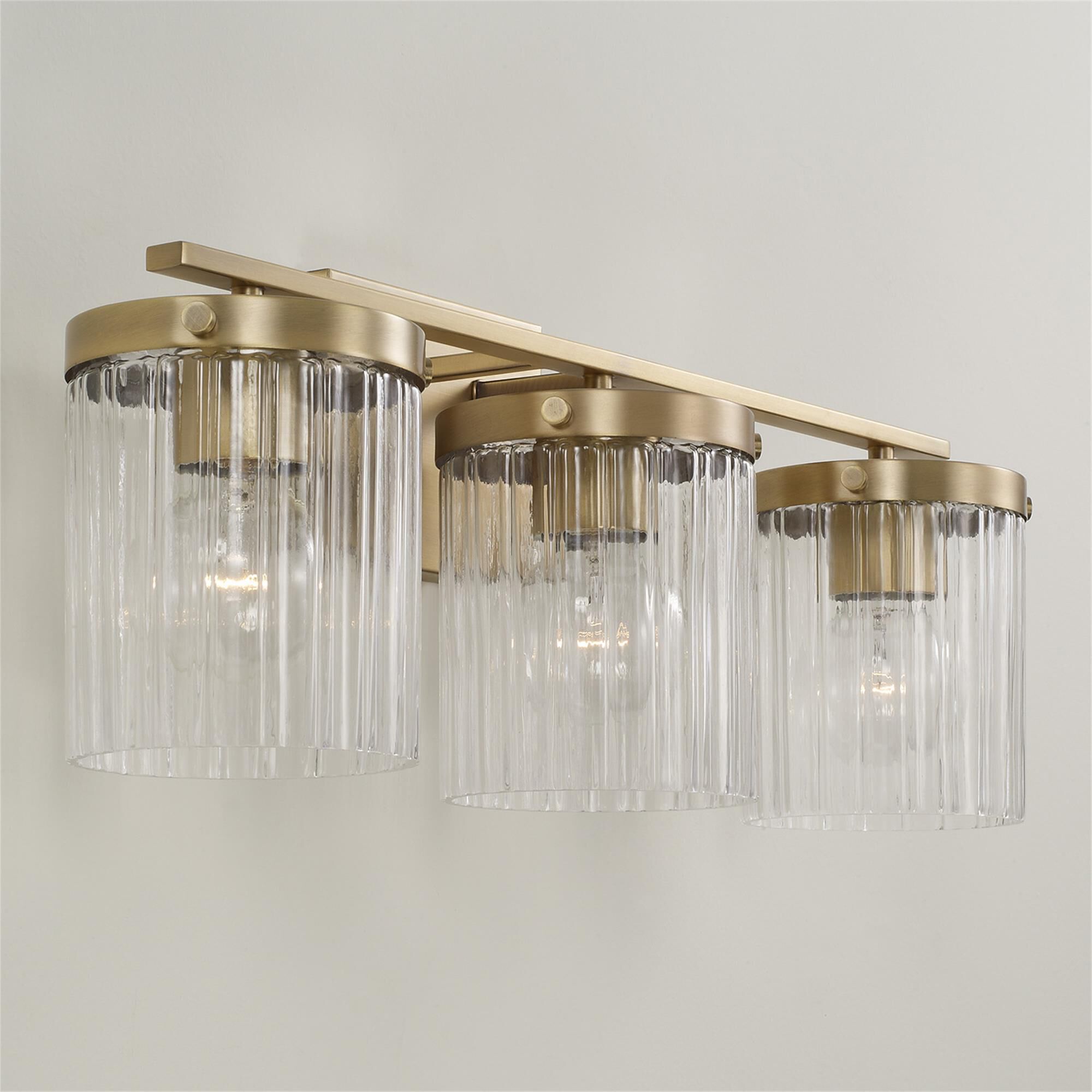 Shown in Aged Brass finish and Beveled Fluted glass