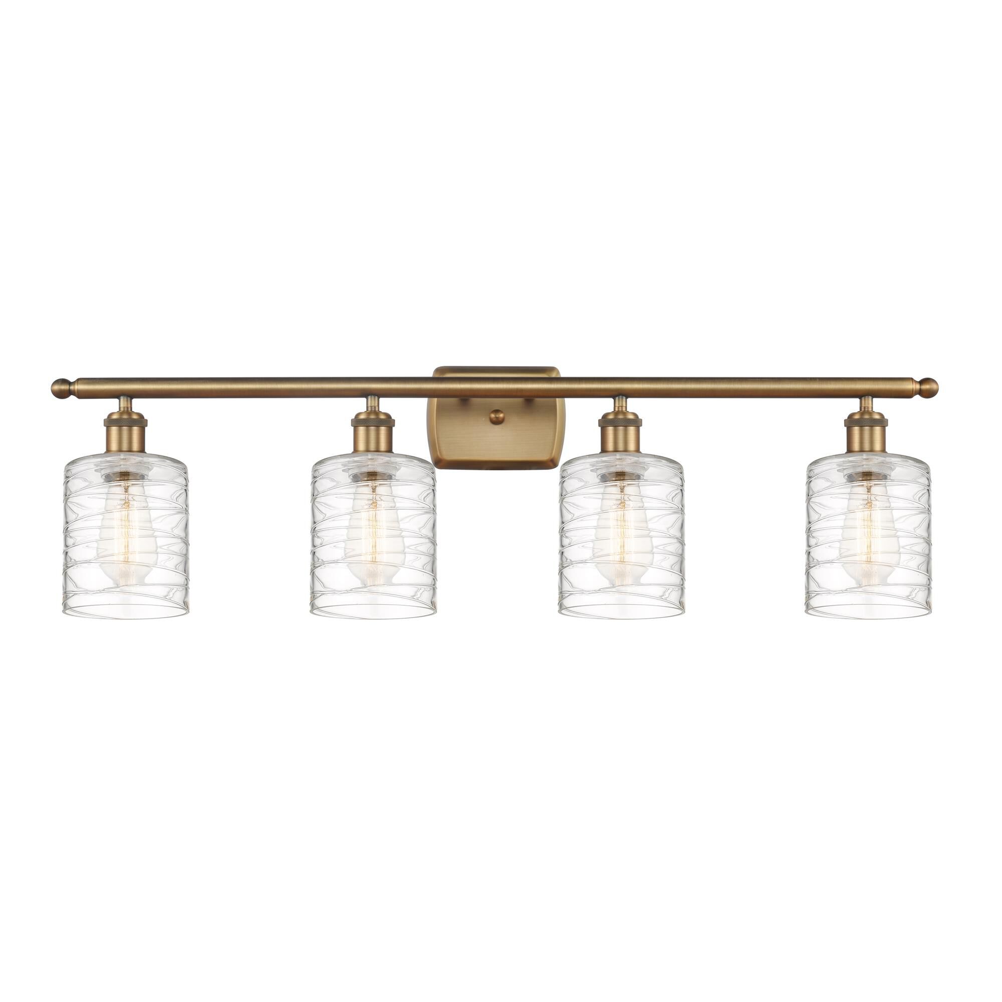 Shown in Brushed Brass finish and Deco Swirl Cobbleskill glass