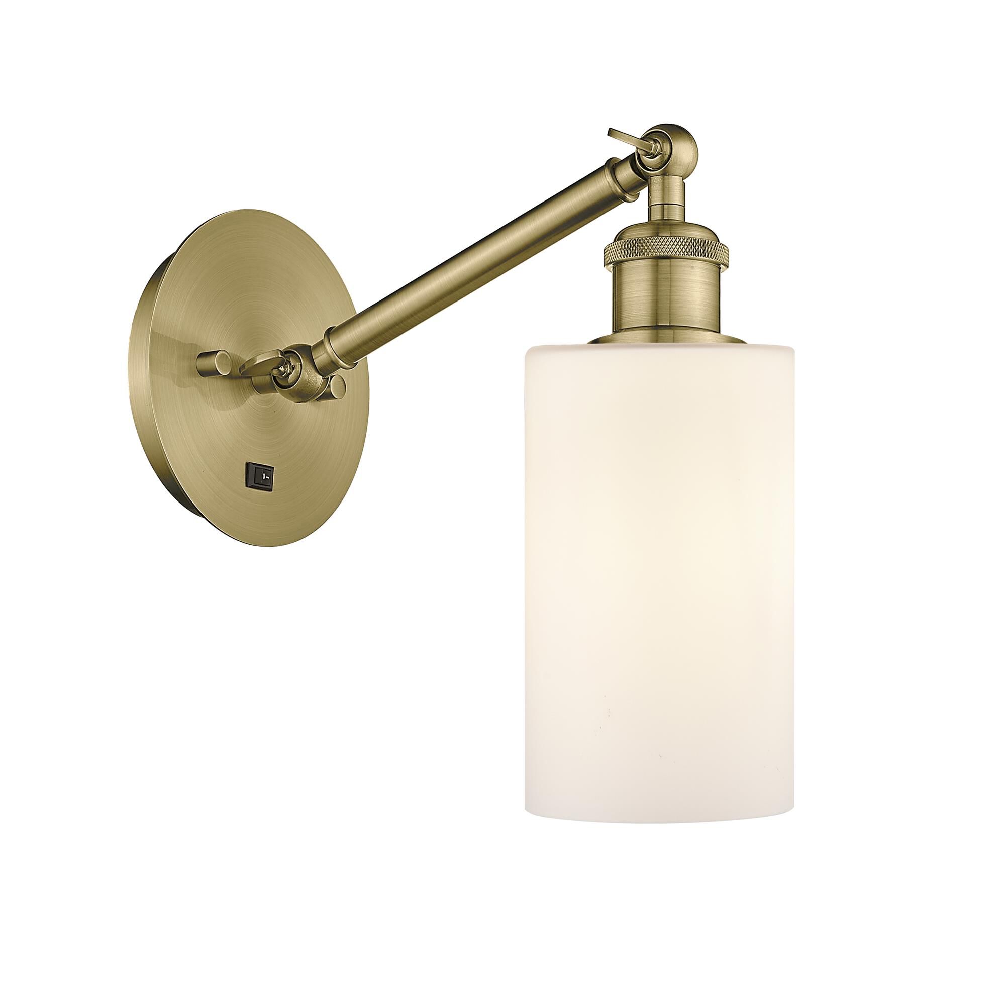 Shown in Antique Brass finish and Matte White Clymer glass