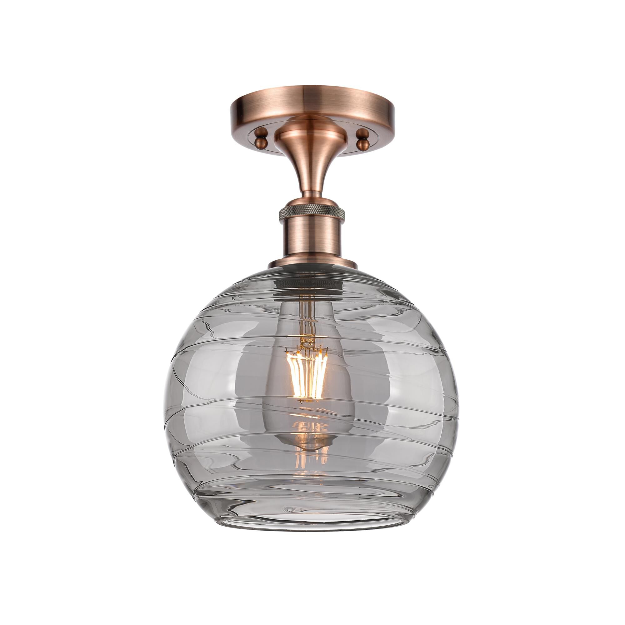 Shown in Antique Copper finish and Light Smoke Deco Swirl glass