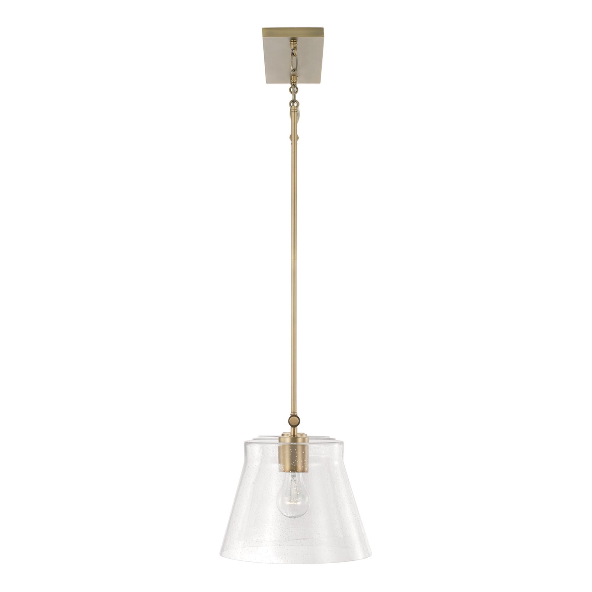 Shown in Aged Brass finish and Clear Seeded glass