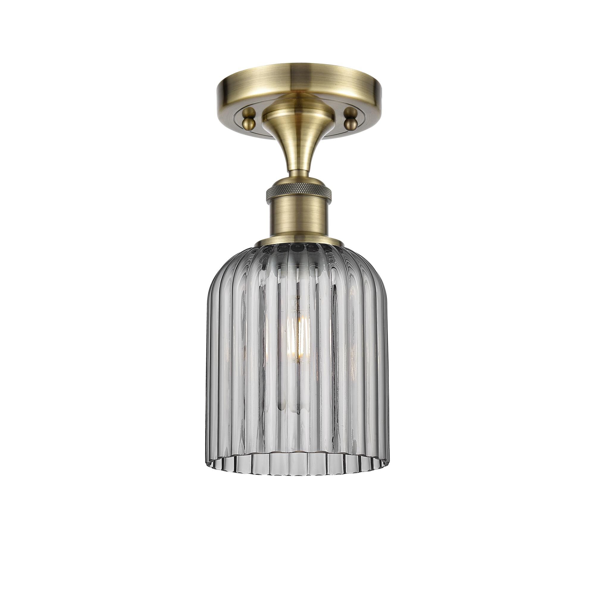 Shown in Antique Brass finish and Light Smoke shade