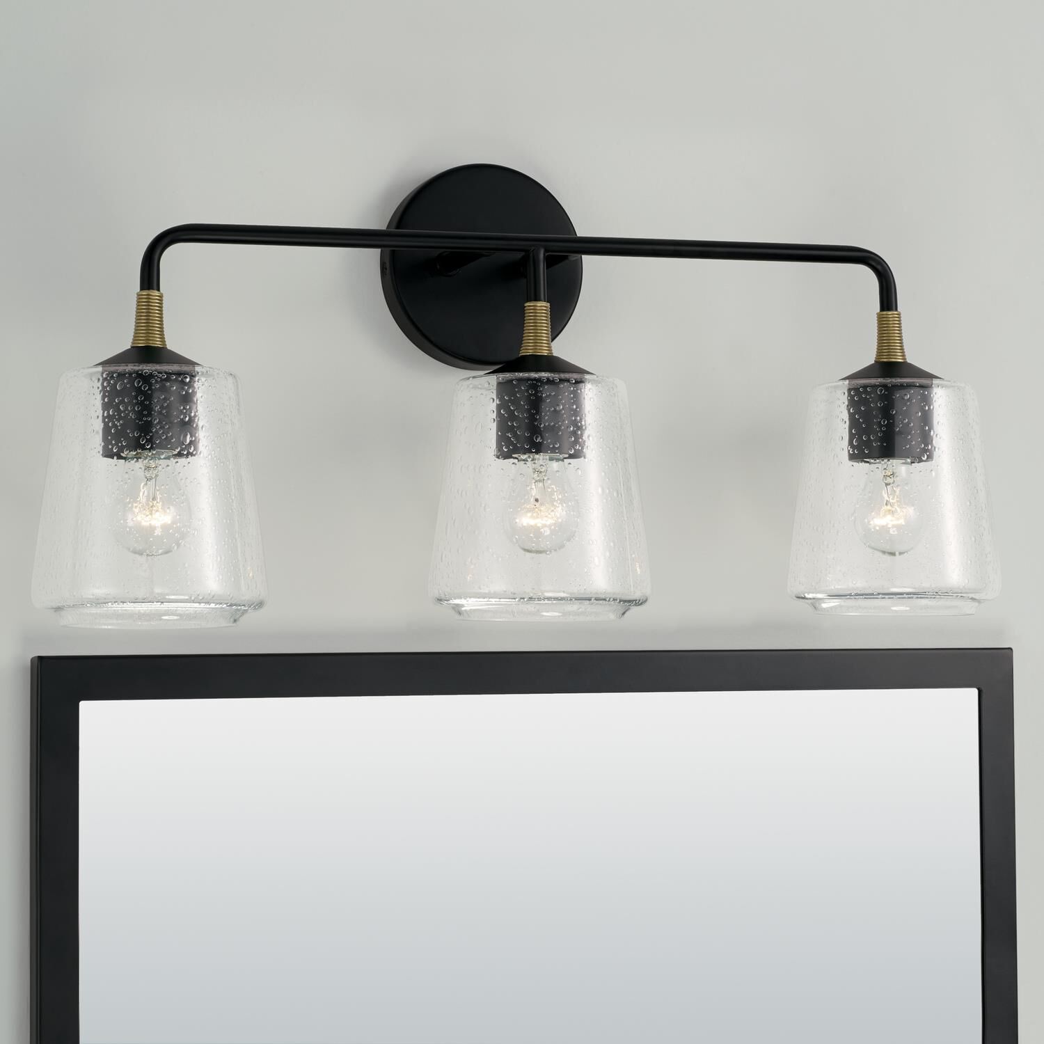 Shown in Matte Black With Brass finish and Clear Seeded glass