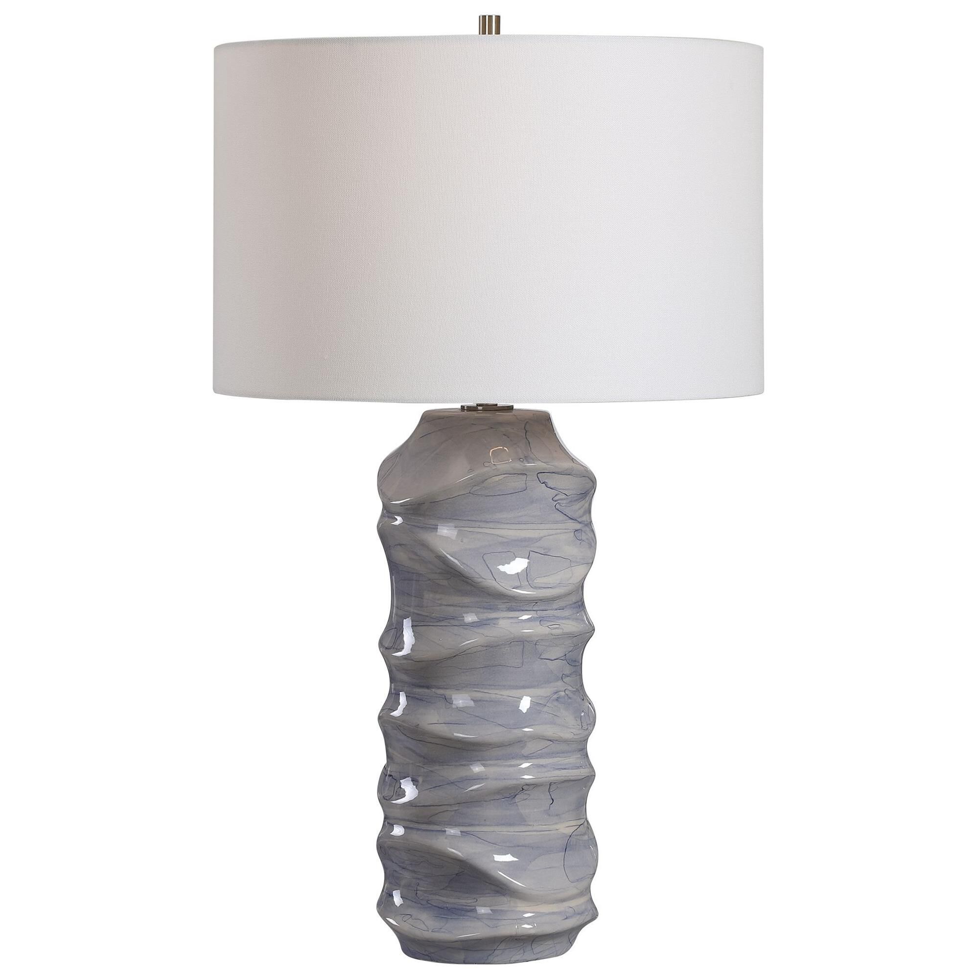 Shown in A Contemporary Take On Classic Blue And White Ceramics, This Table Lamp Features A Unique Sculpted D finish and Round Drum Hardback shade