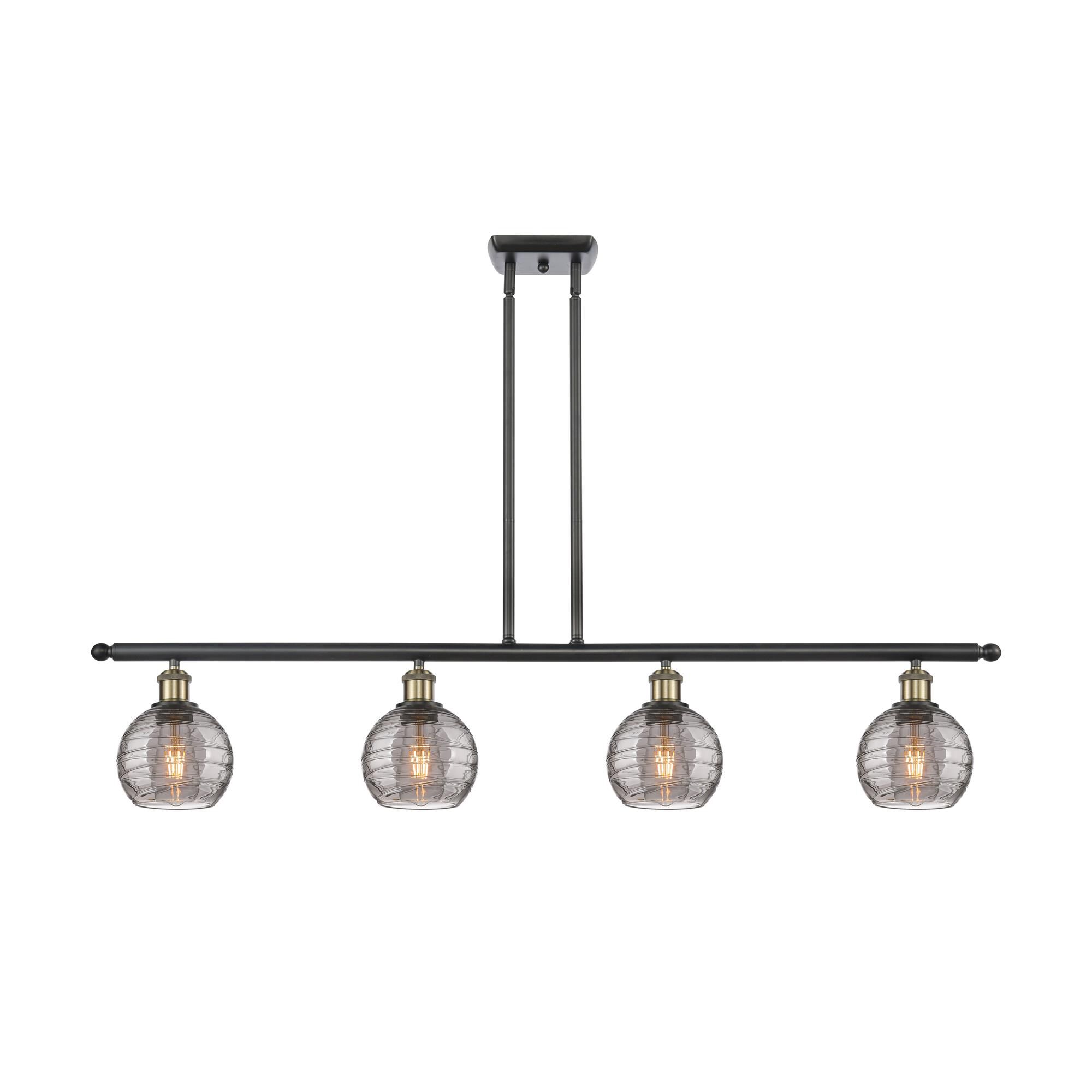 Shown in Black Antique Brass finish and Light Smoke Deco Swirl glass