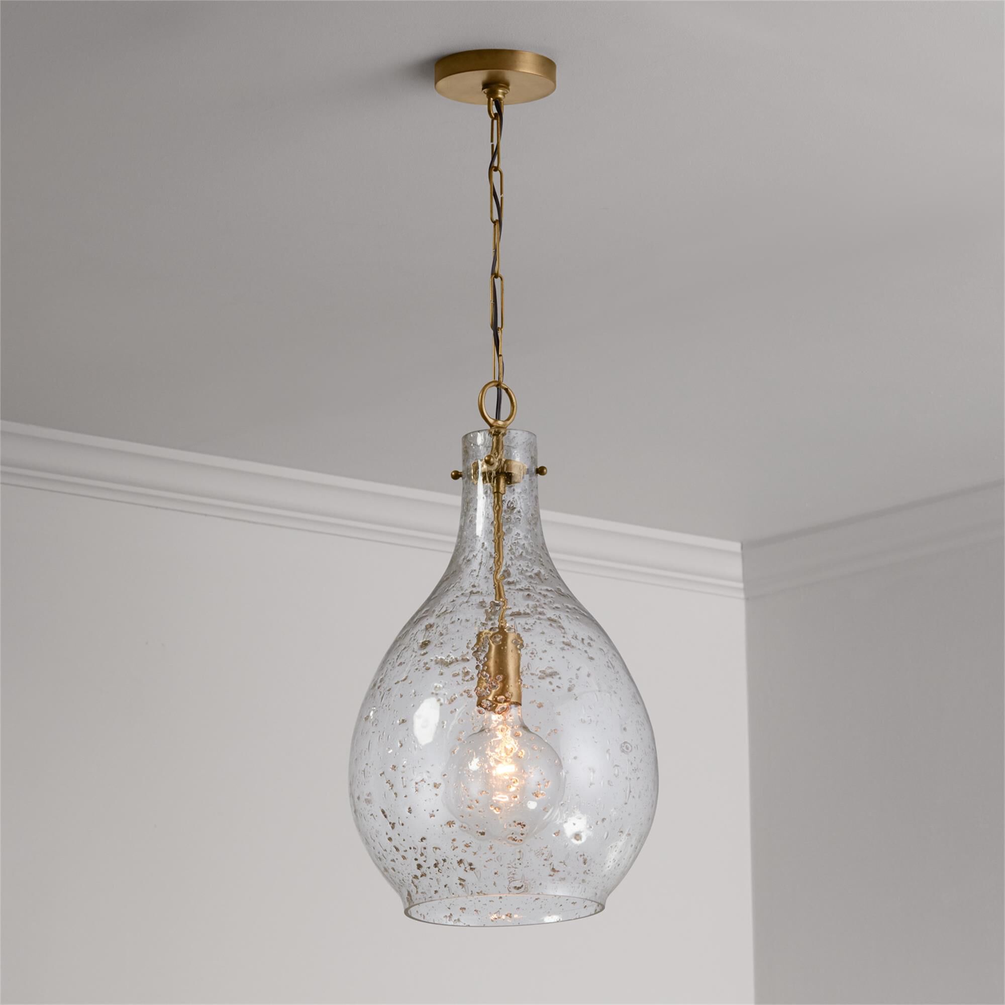 Shown in Patinaed Brass finish and Stone Seeded glass