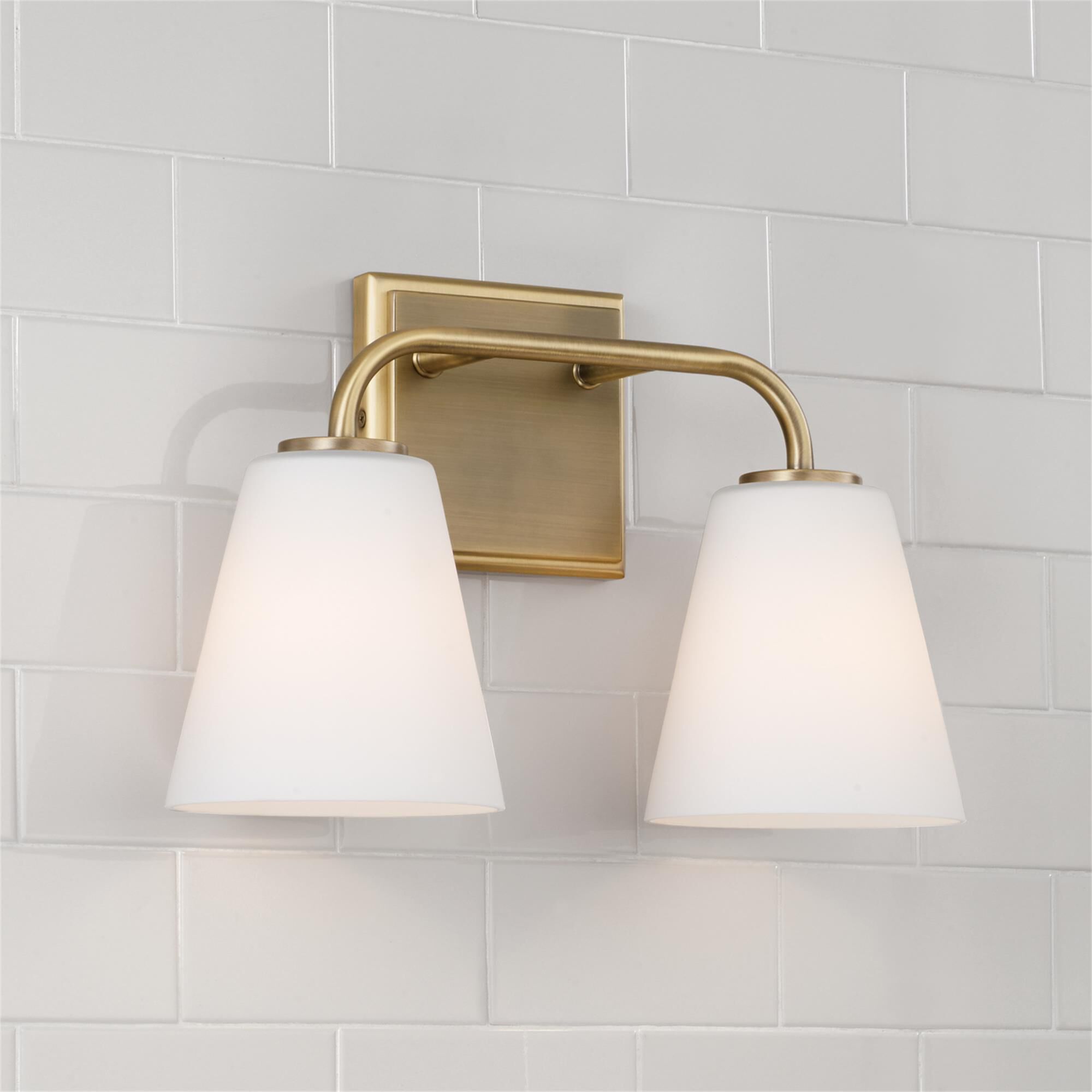 Shown in Aged Brass finish and Soft White glass