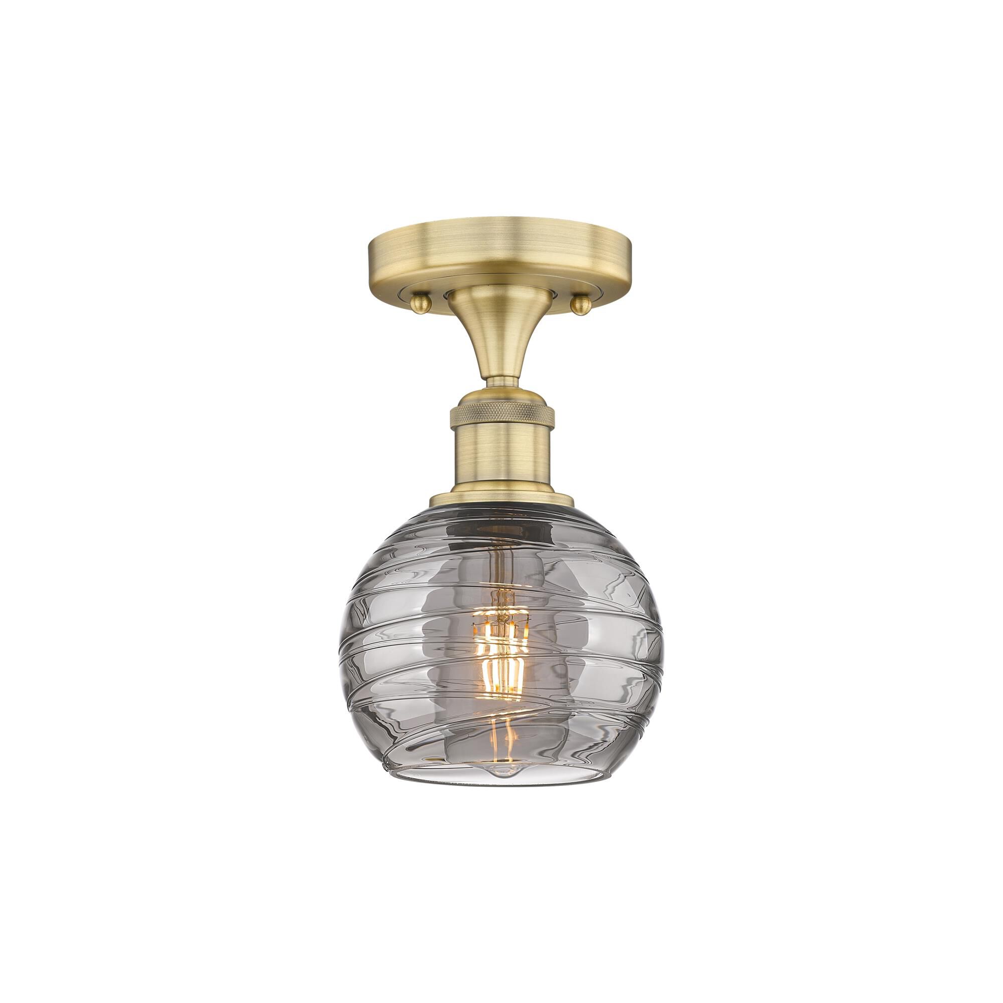 Shown in Brushed Brass finish and Light Smoke Deco Swirl glass