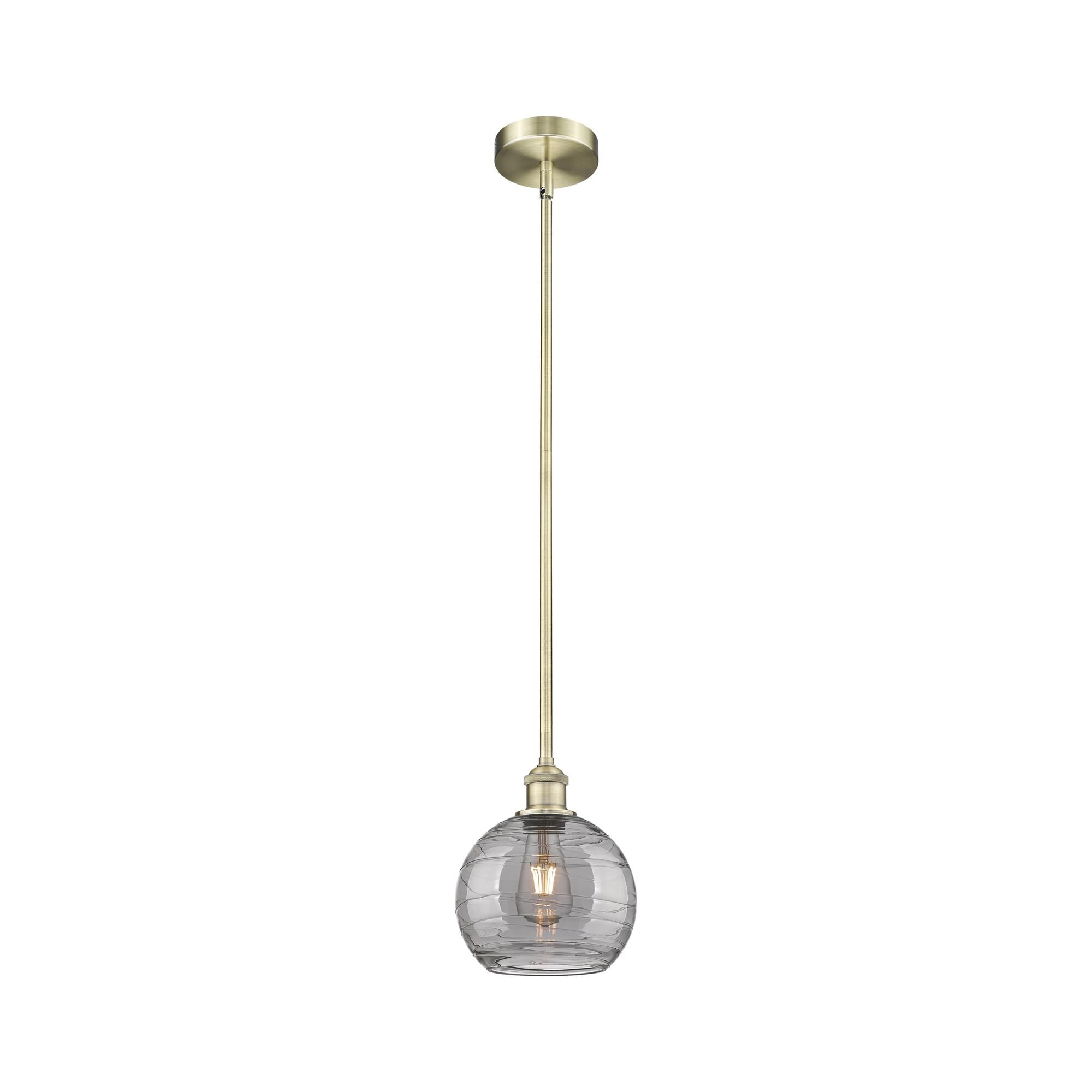 Shown in Antique Brass finish and Light Smoke Deco Swirl glass