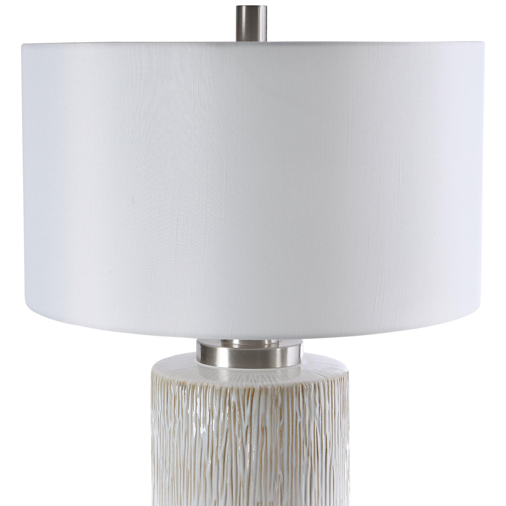 Shown in This Lamp Showcases An Aged White Ceramic Base Accented With Charcoal Flecks And Textured Beige Drip finish and Round Hardback Drum shade