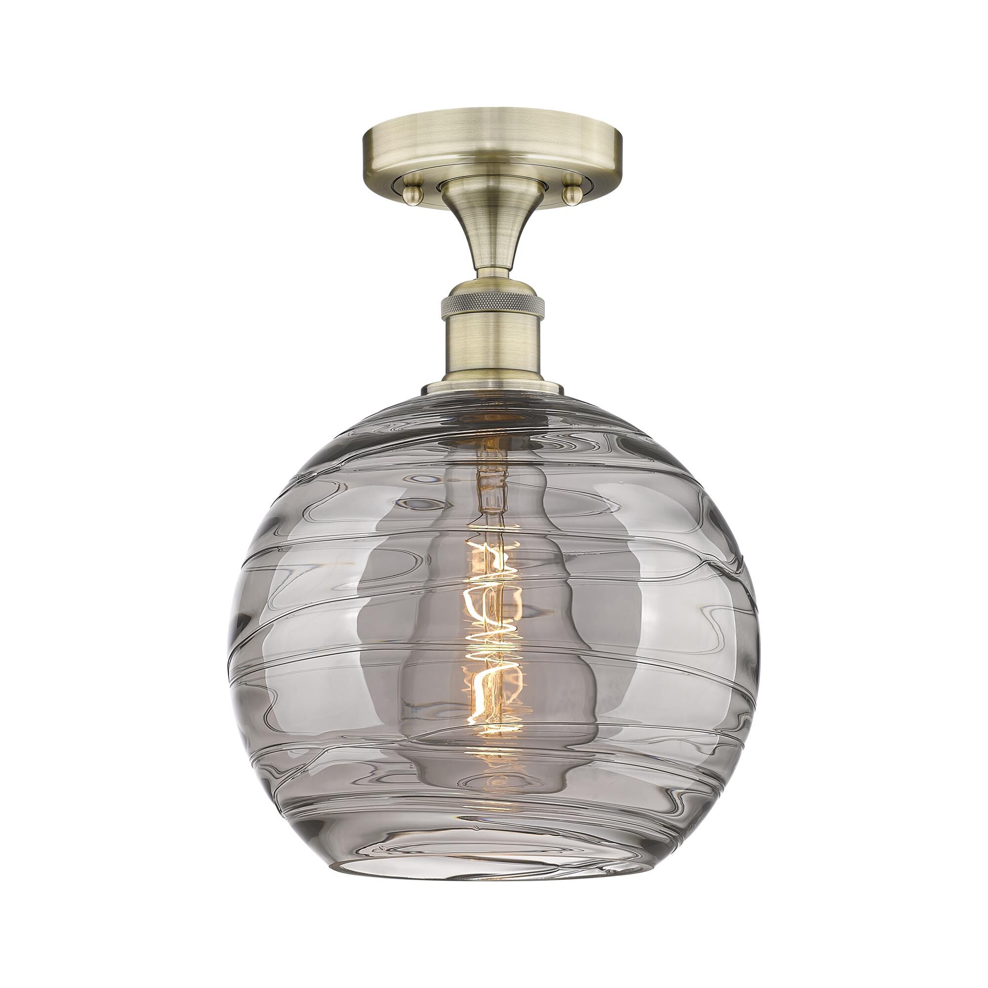 Shown in Antique Brass finish and Light Smoke Deco Swirl glass