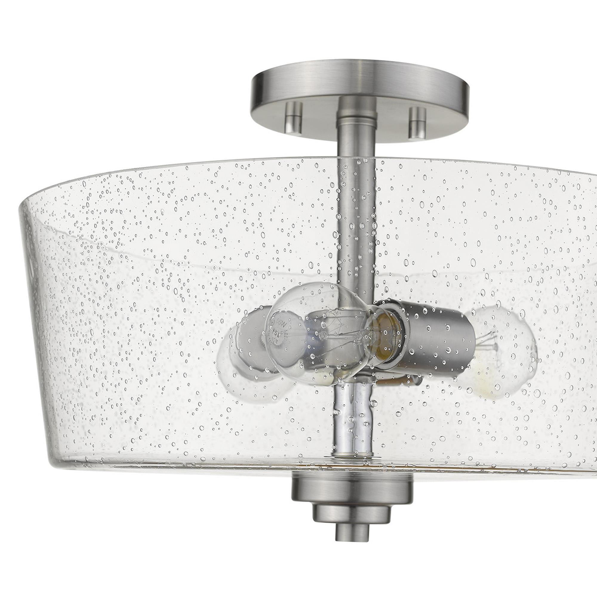 Shown in Satin Nickel finish and Clear glass and Clear, Seeded Drum Shaped Glass shade