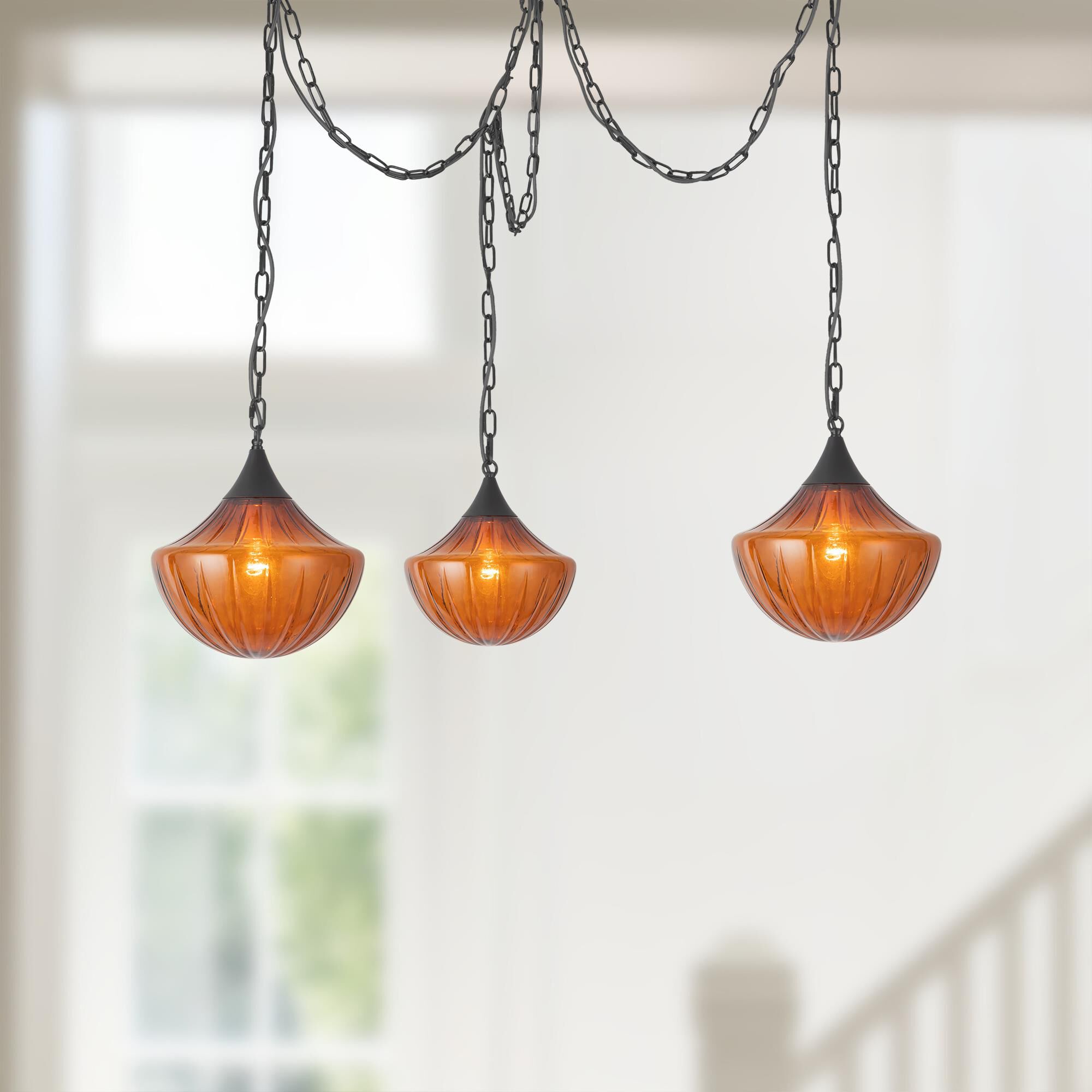 Shown in Matte Black finish and Amber Ribbed glass