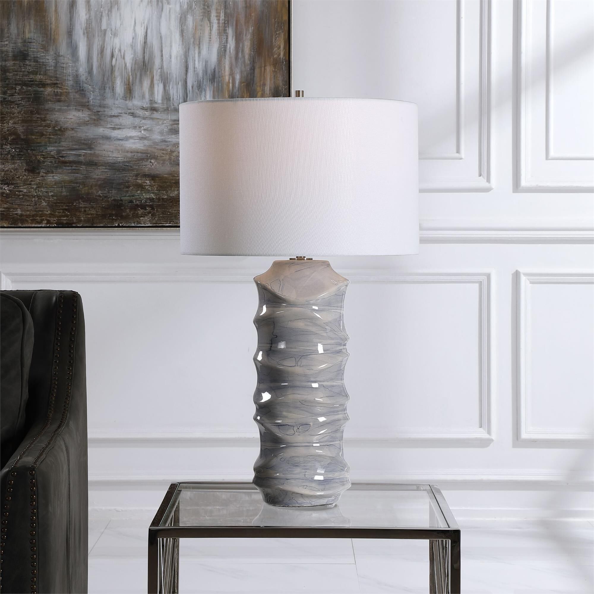 Shown in A Contemporary Take On Classic Blue And White Ceramics, This Table Lamp Features A Unique Sculpted D finish and Round Drum Hardback shade