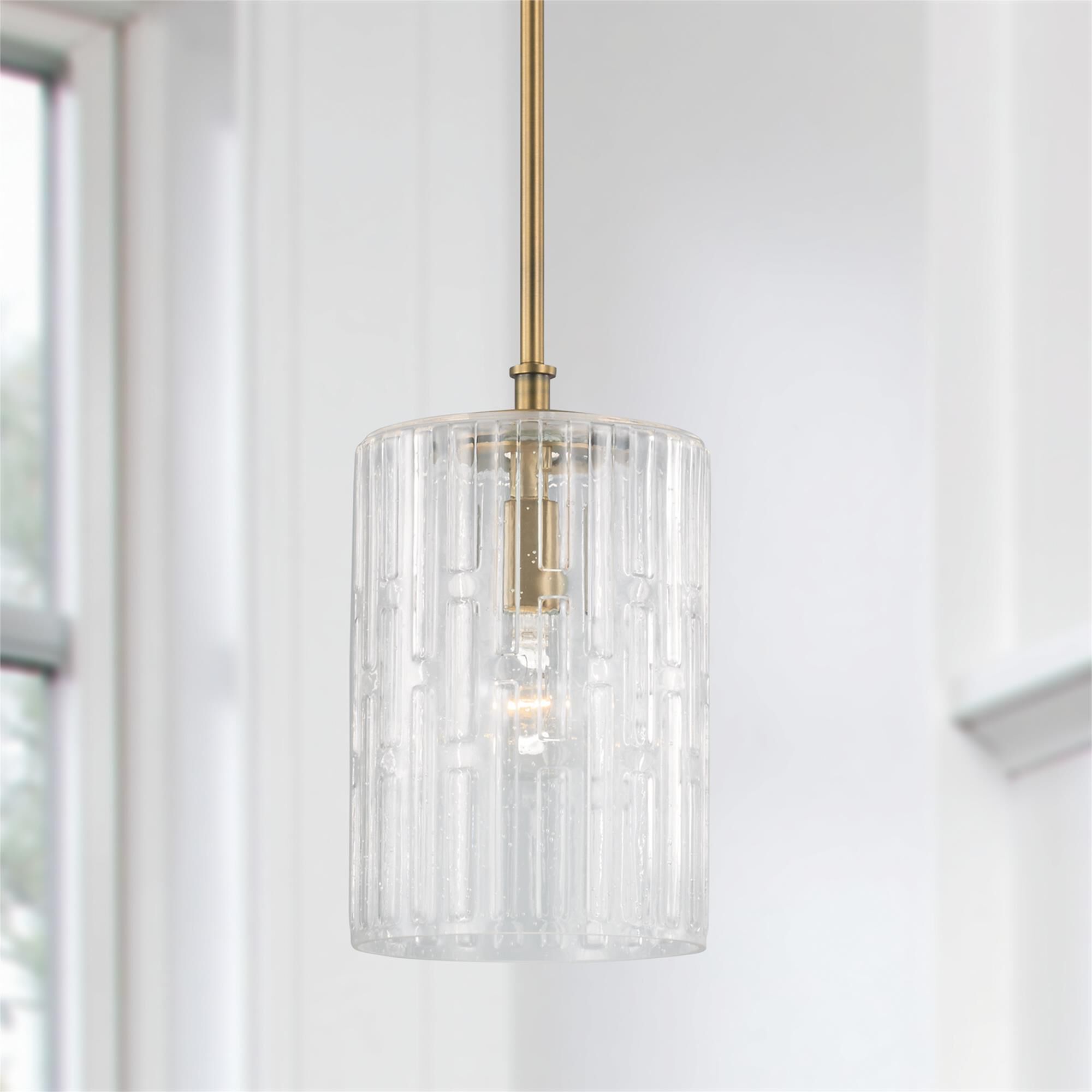 Shown in Aged Brass finish and Embossed Seeded glass