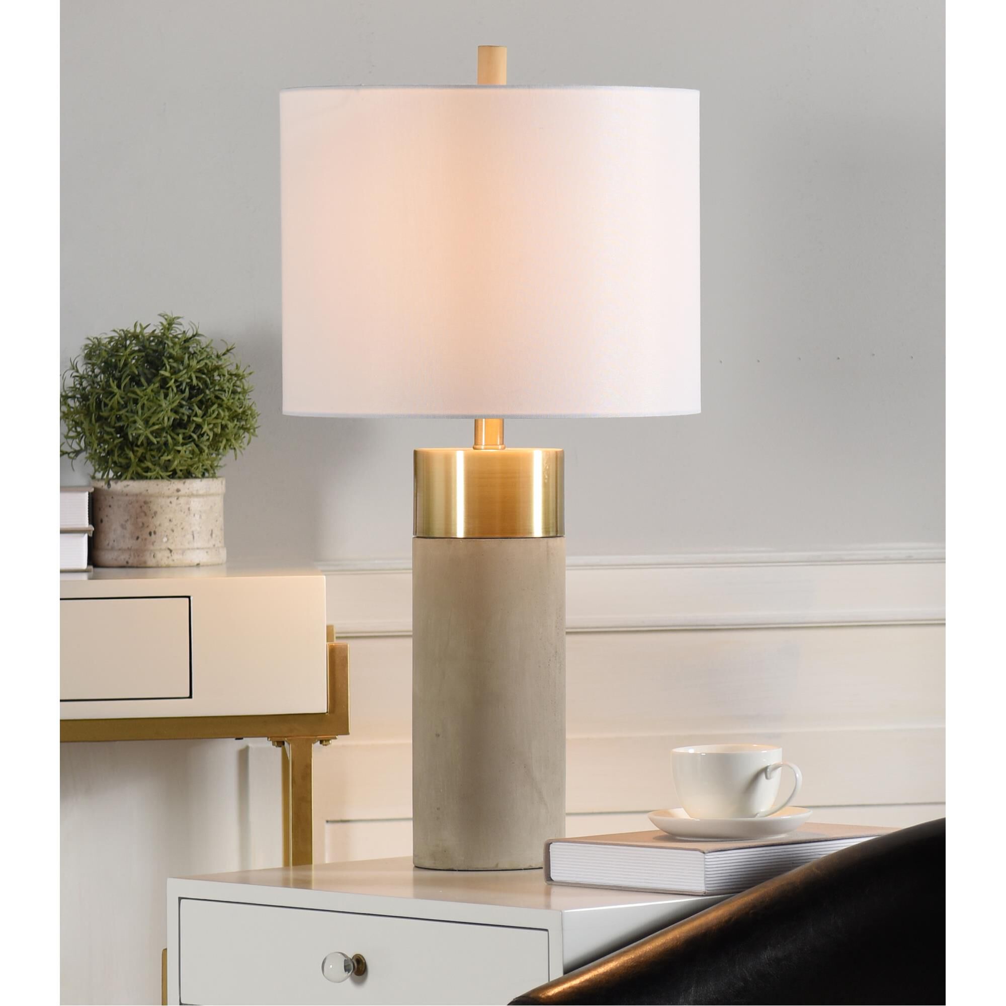 Shown in Soft Brass, Natural Concrete finish and Brussels White Hardback Fabric shade