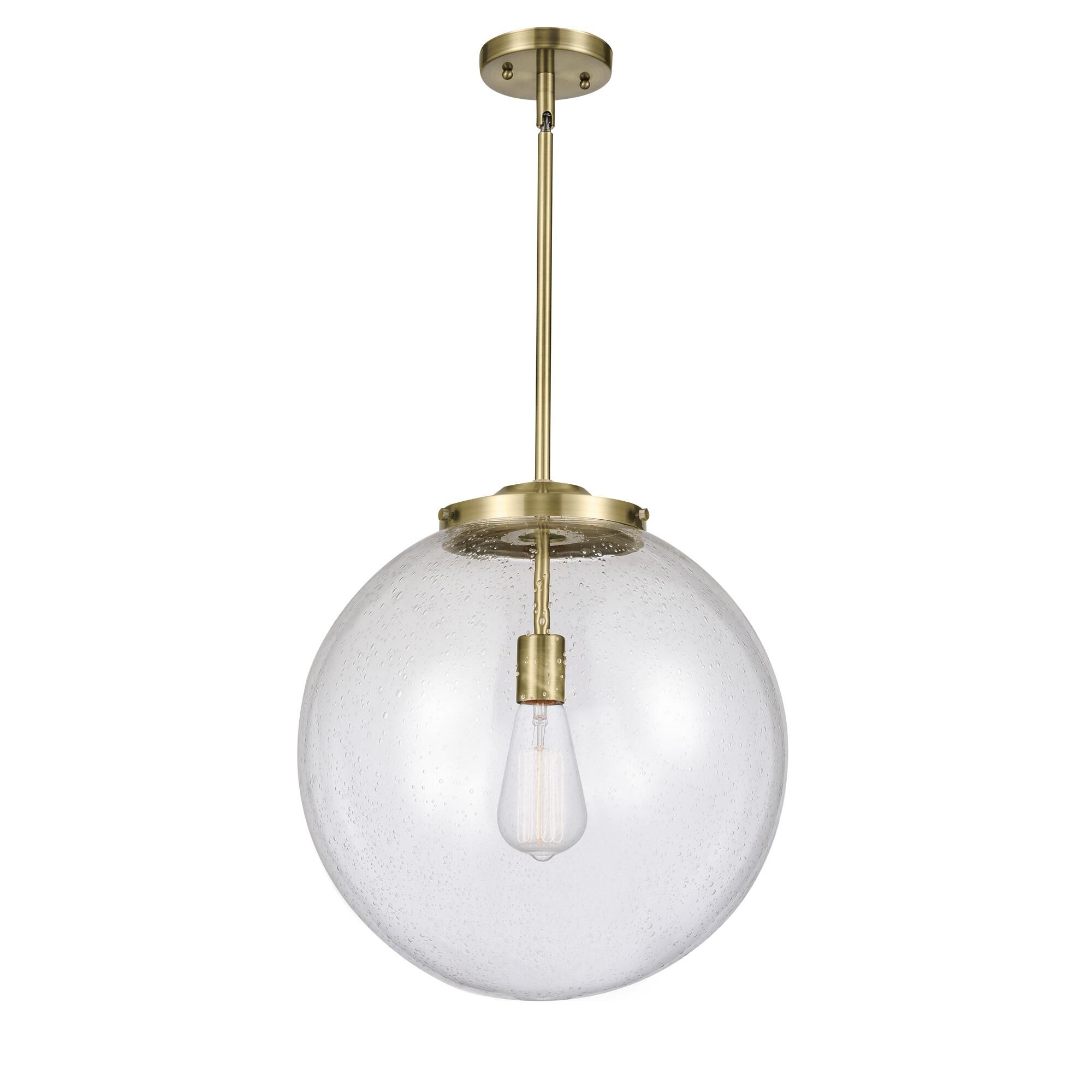 Shown in Antique Brass finish and Seedy Beacon glass