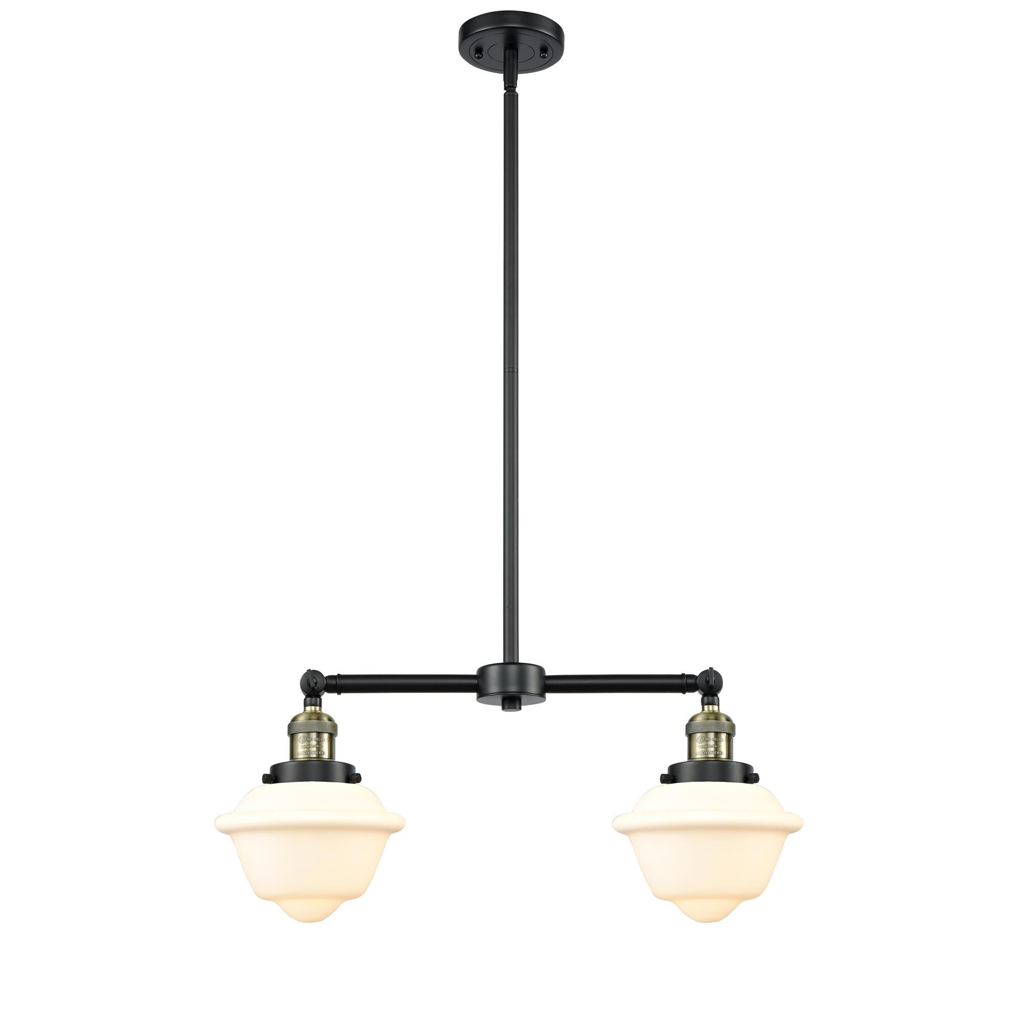 Shown in Black Antique Brass finish and Matte White Cased glass
