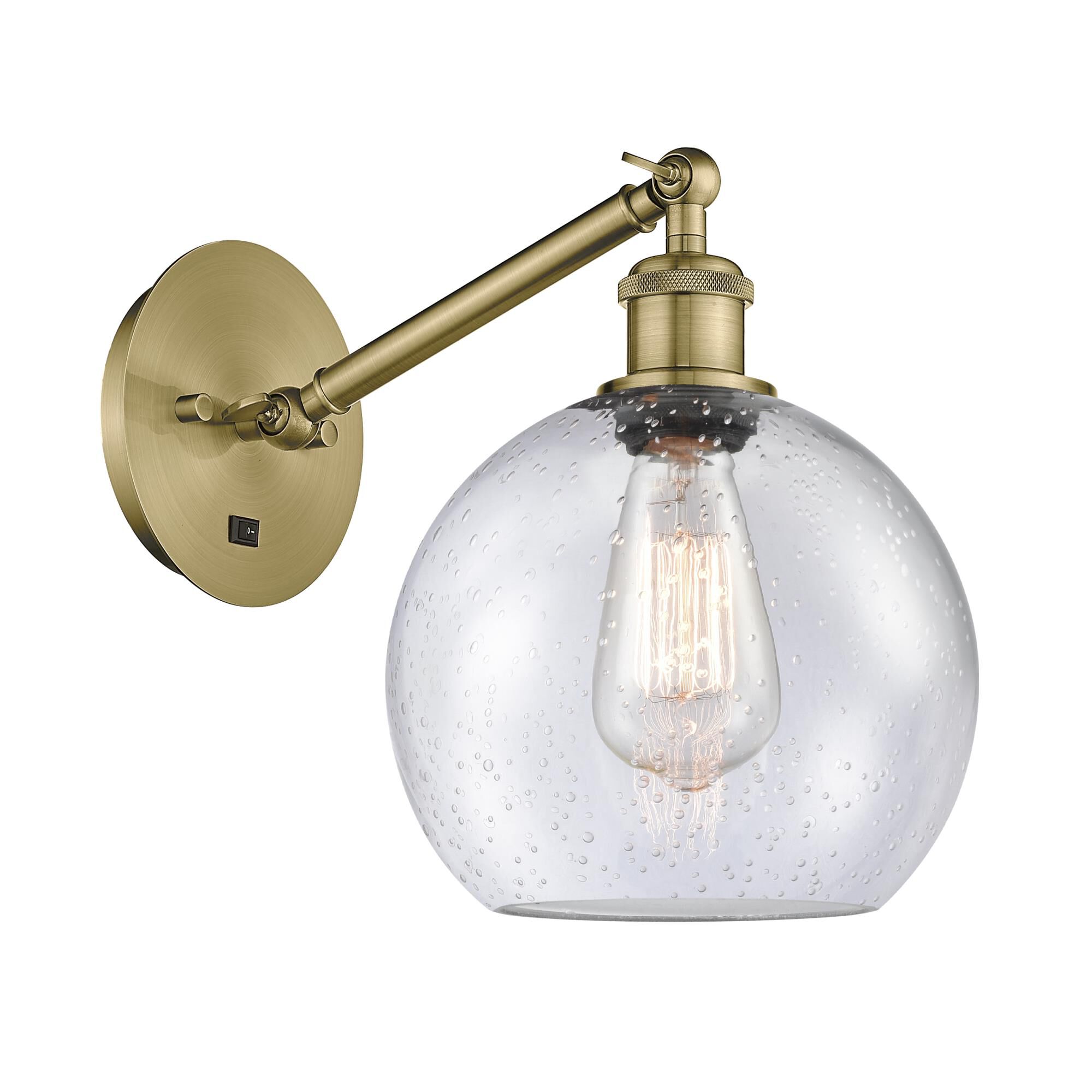 Shown in Antique Brass finish and Seedy Athens glass