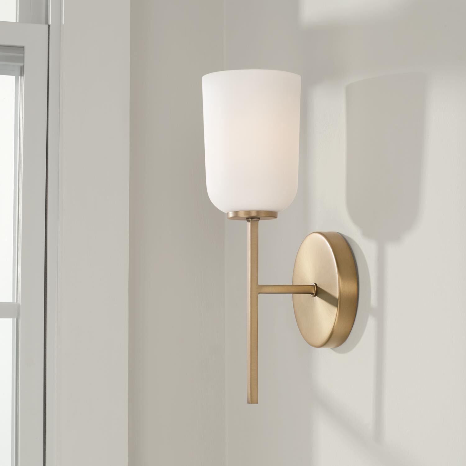 Shown in Aged Brass finish and Soft White glass