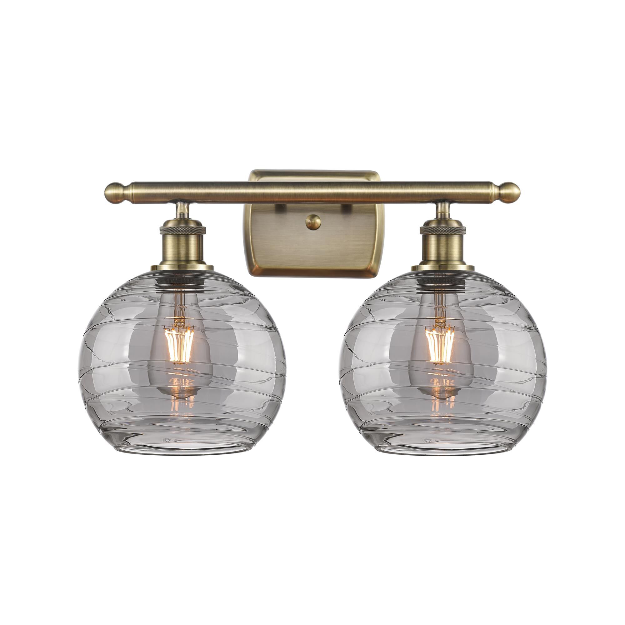 Shown in Antique Brass finish and Light Smoke Deco Swirl glass