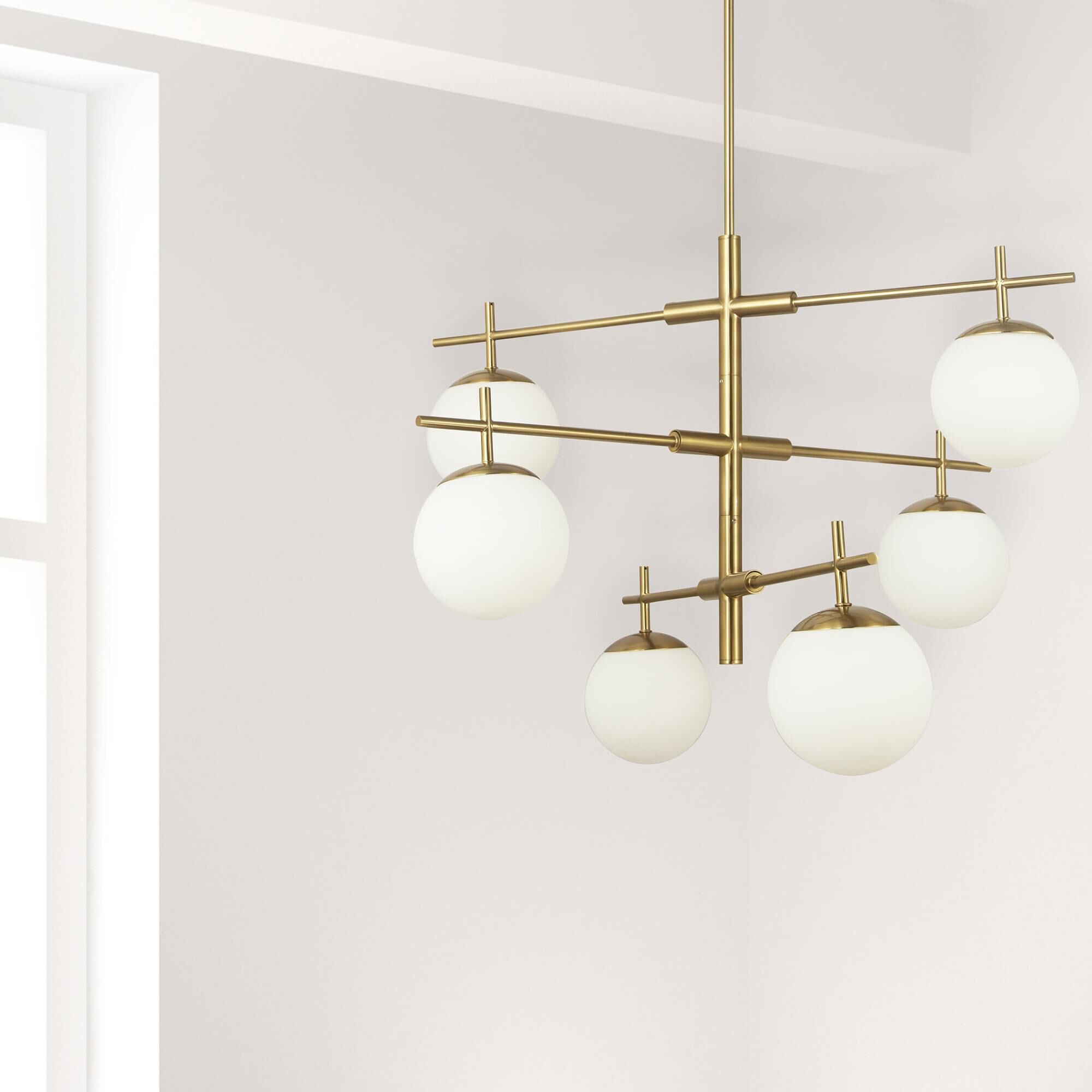 Shown in Aged Brass and White finish and White Globe glass