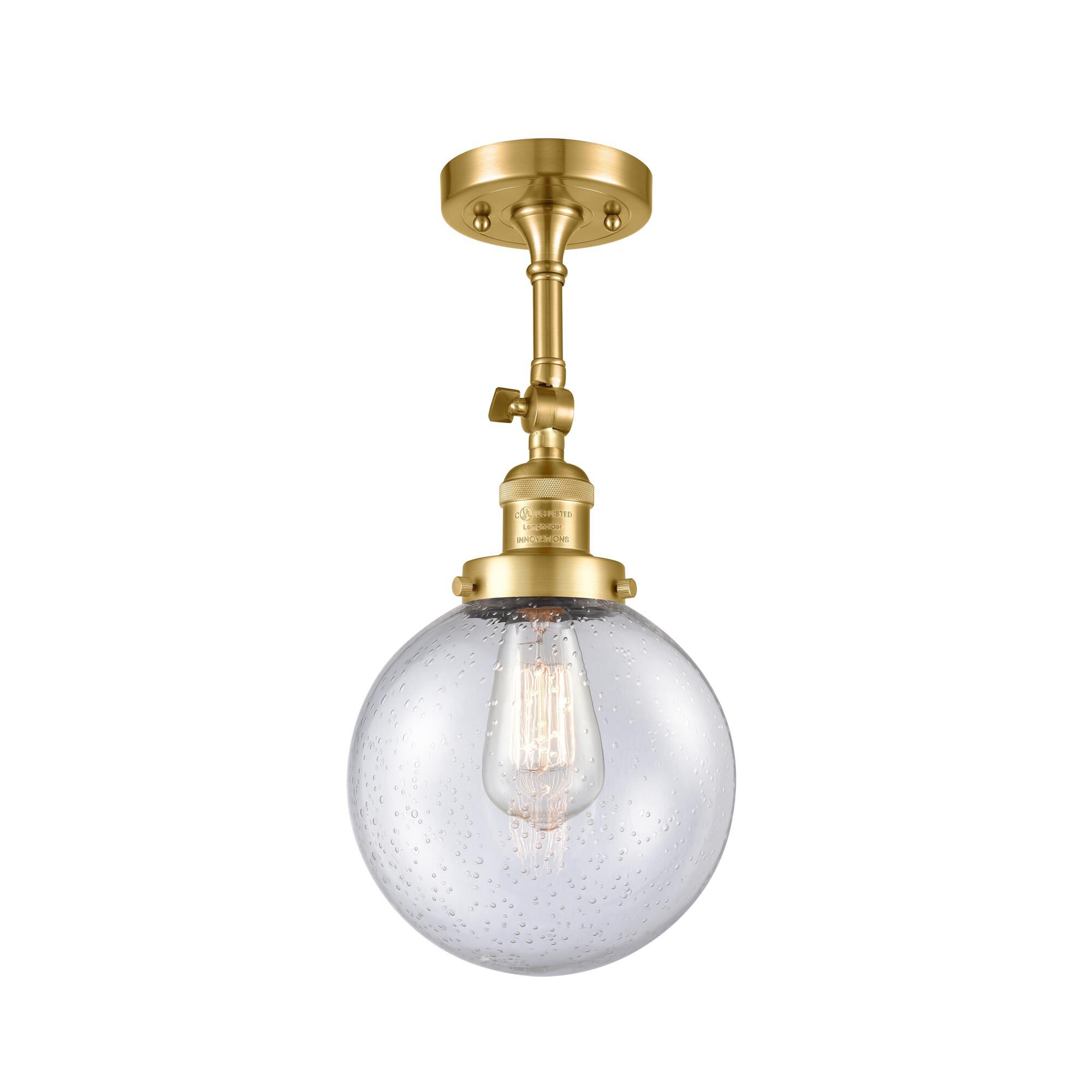 Shown in Satin Gold finish and Seedy glass and None accent