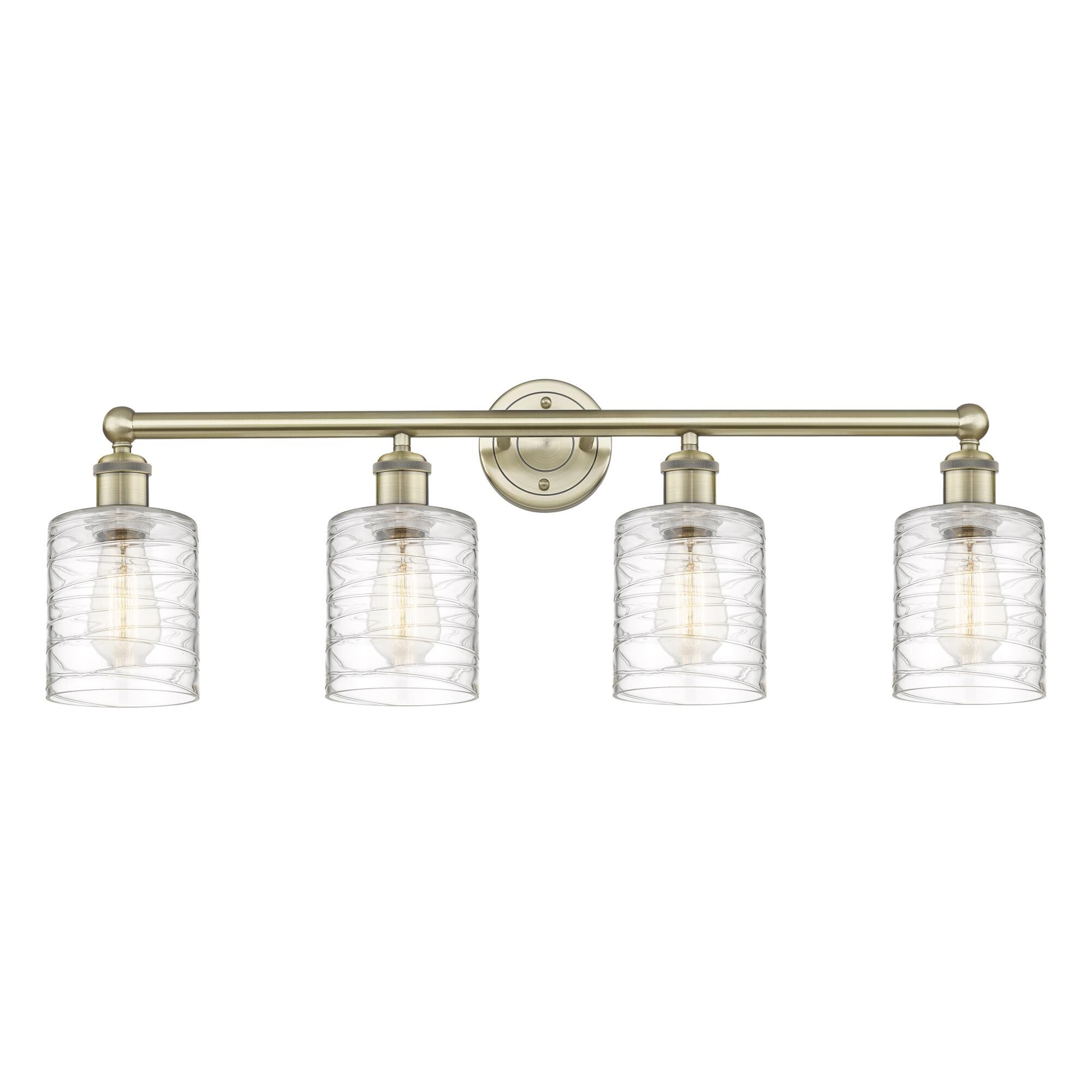 Shown in Antique Brass finish and Deco Swirl glass