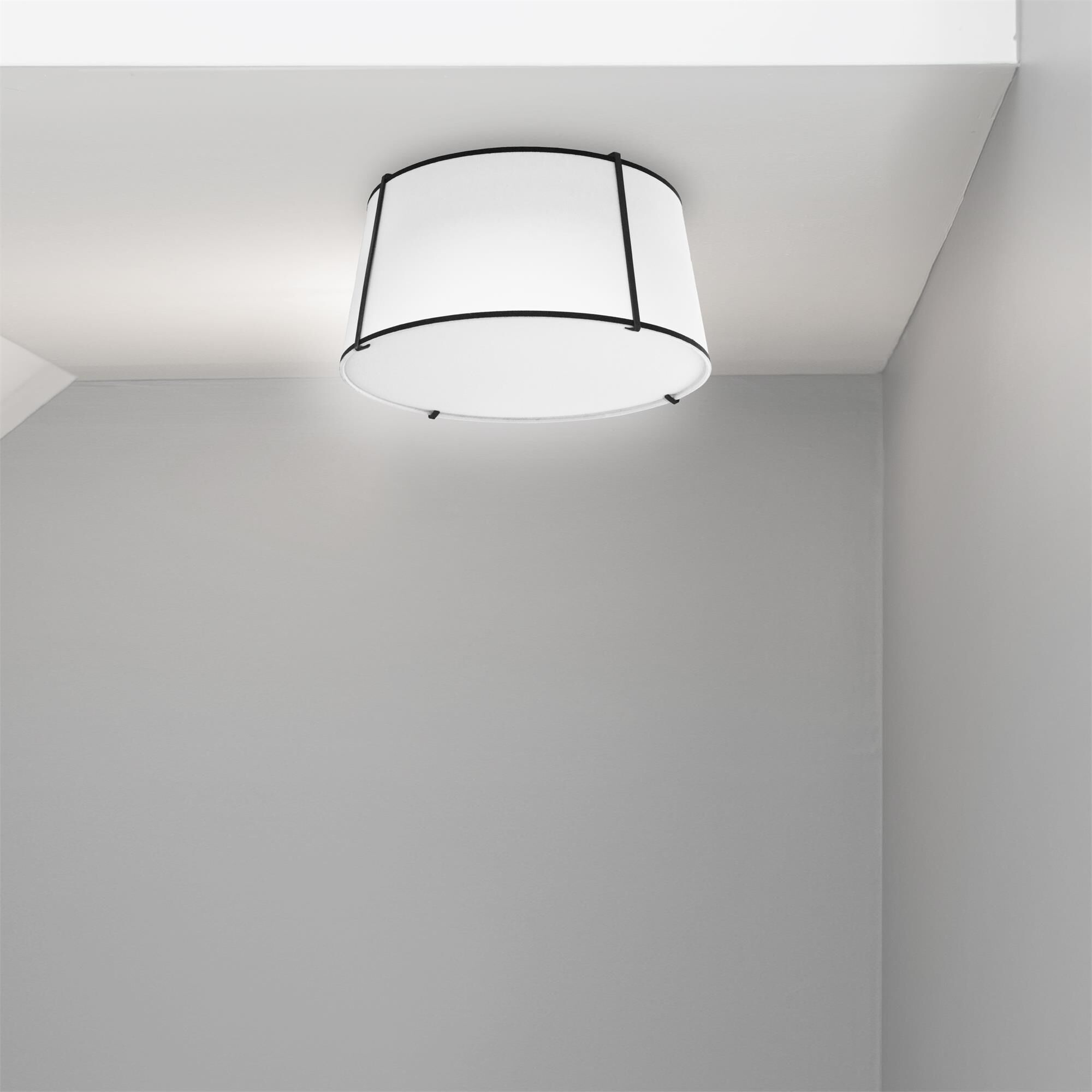 Shown in Black and White finish and White Fabric Tapered Drum shade