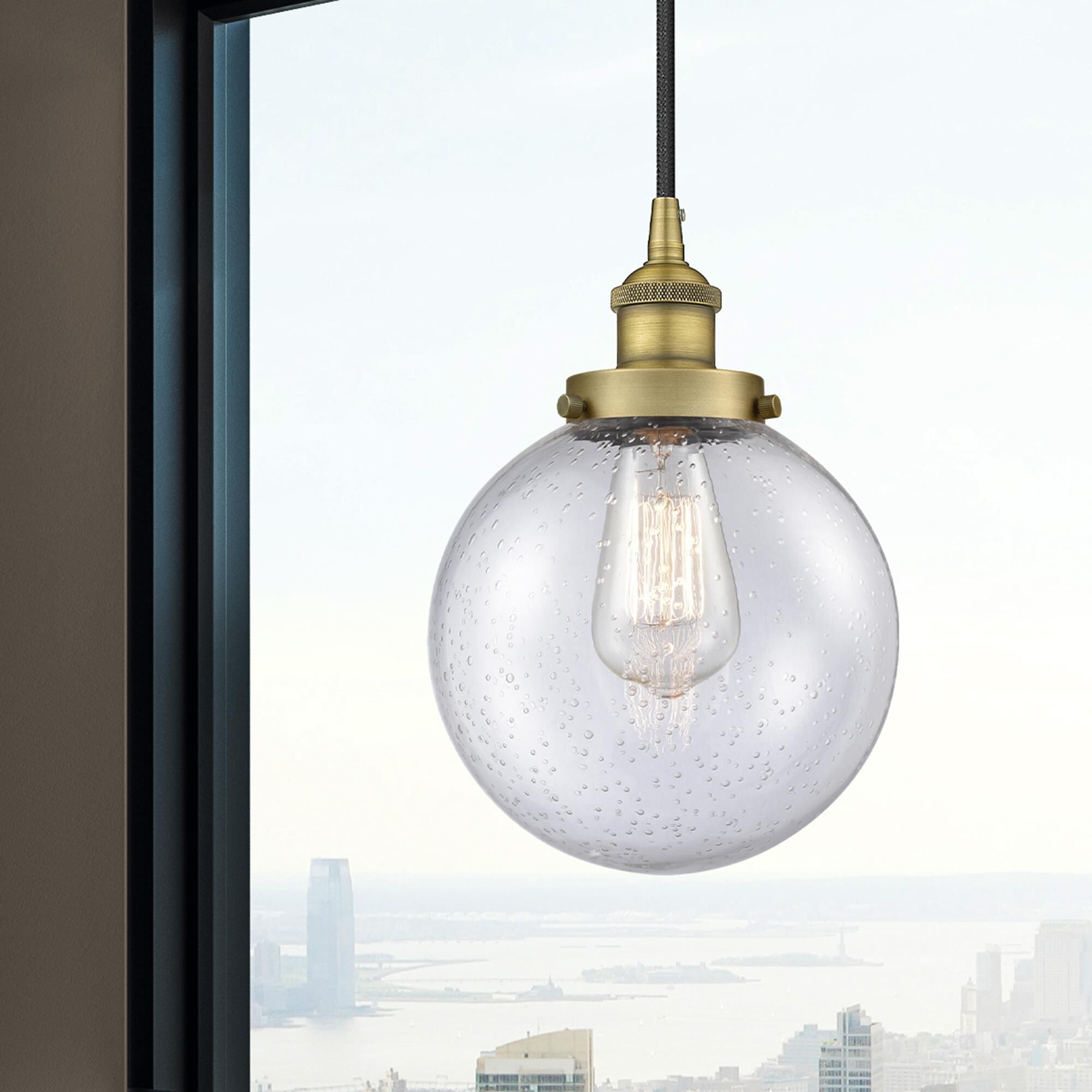 Shown in Brushed Brass finish and Seedy Beacon glass