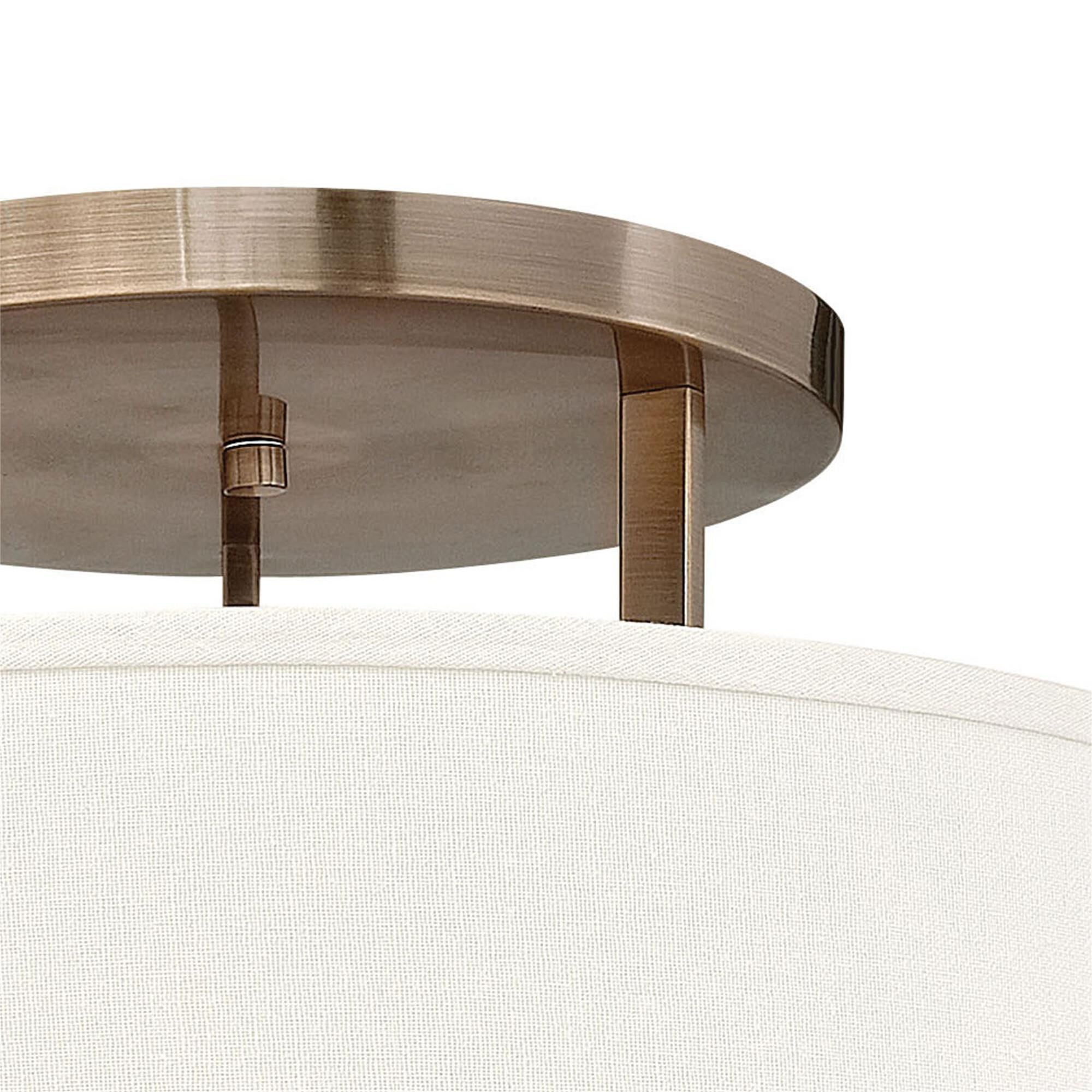 Shown in Brushed Bronze finish and Off-White Linen Hardback shade