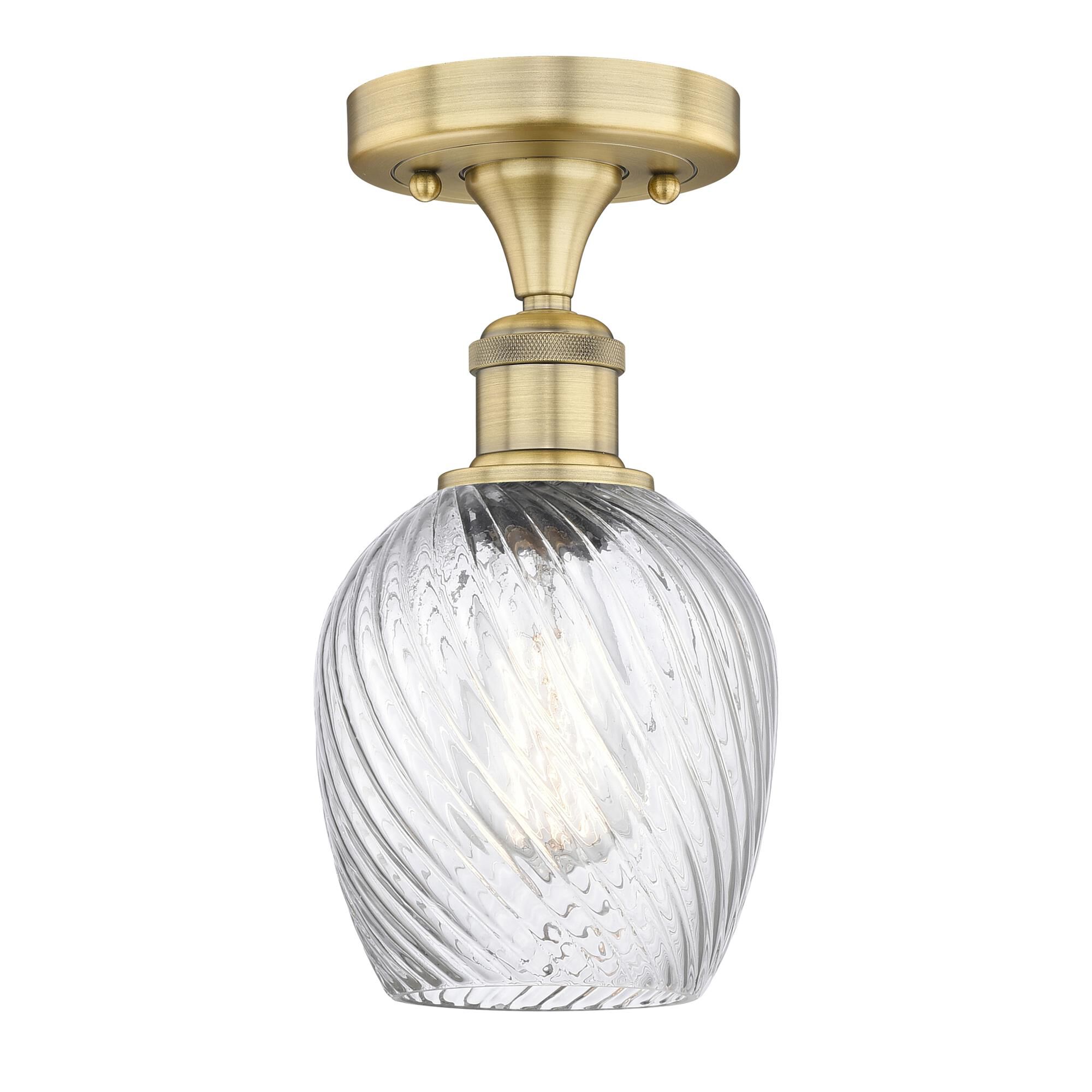 Shown in Brushed Brass finish and Clear Spiral Fluted glass