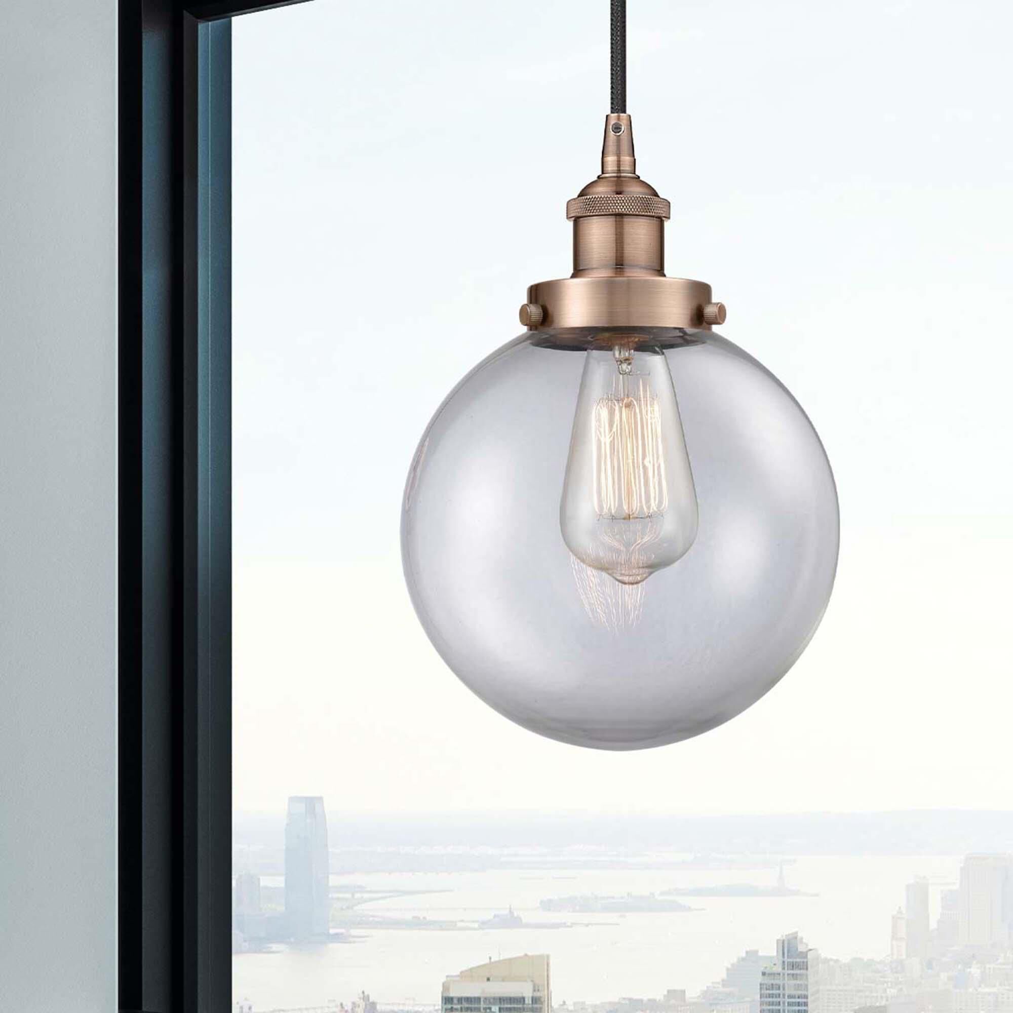 Shown in Antique Copper finish and Clear Beacon glass