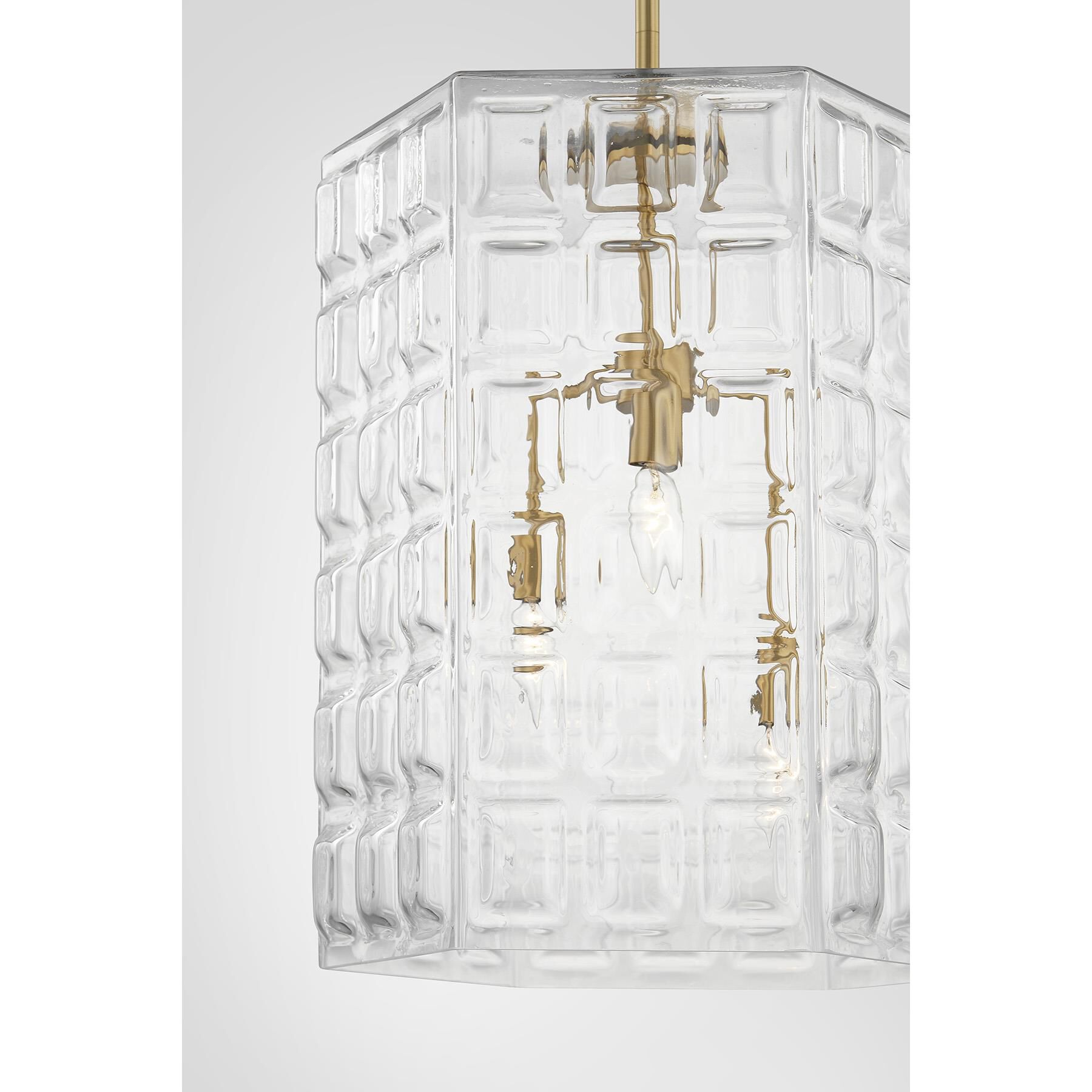 Shown in Warm Brass finish and Clear Geometric glass