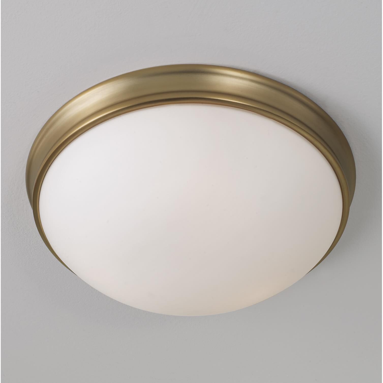 Shown in Aged Brass finish and Soft White glass