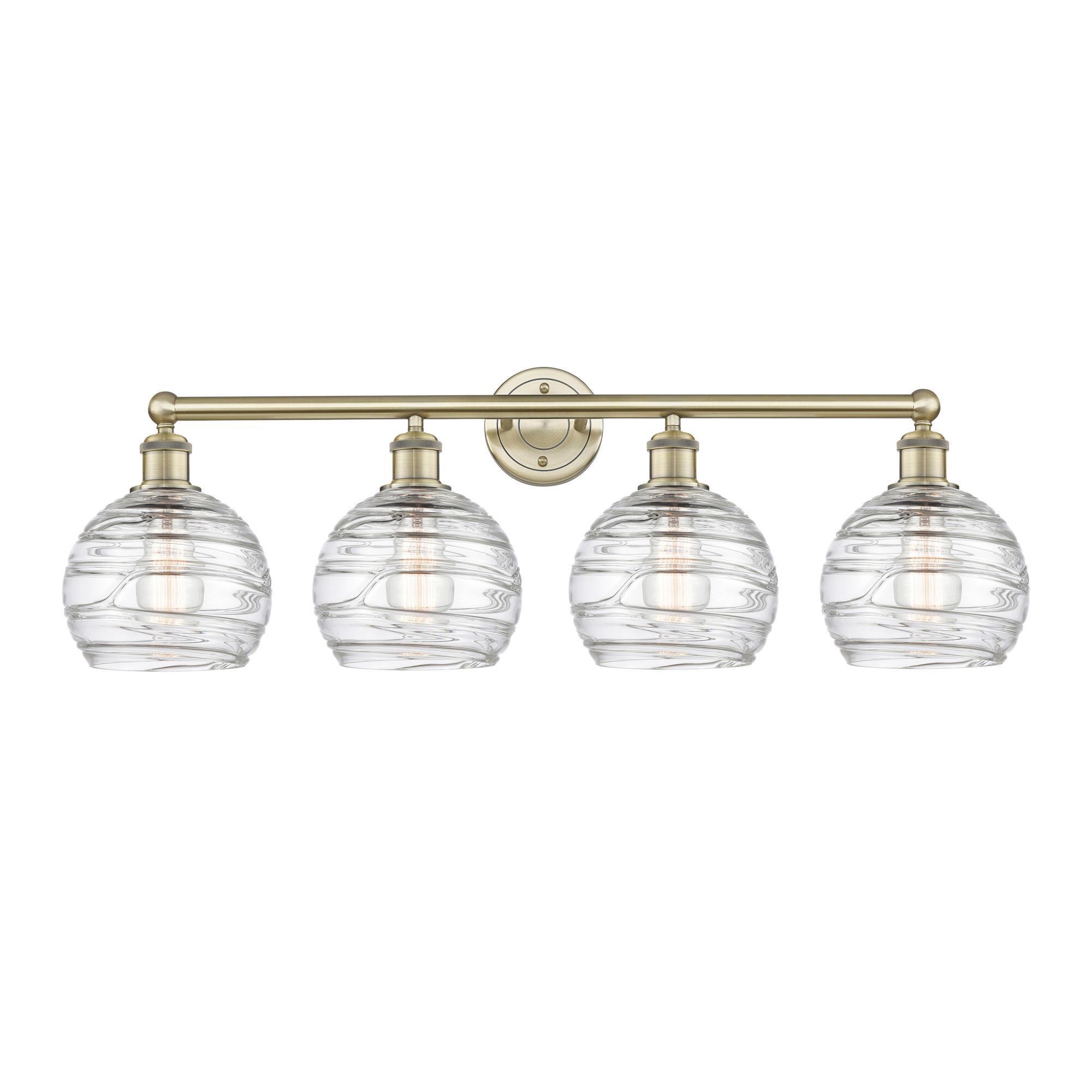 Shown in Antique Brass finish and Clear Deco Swirl glass