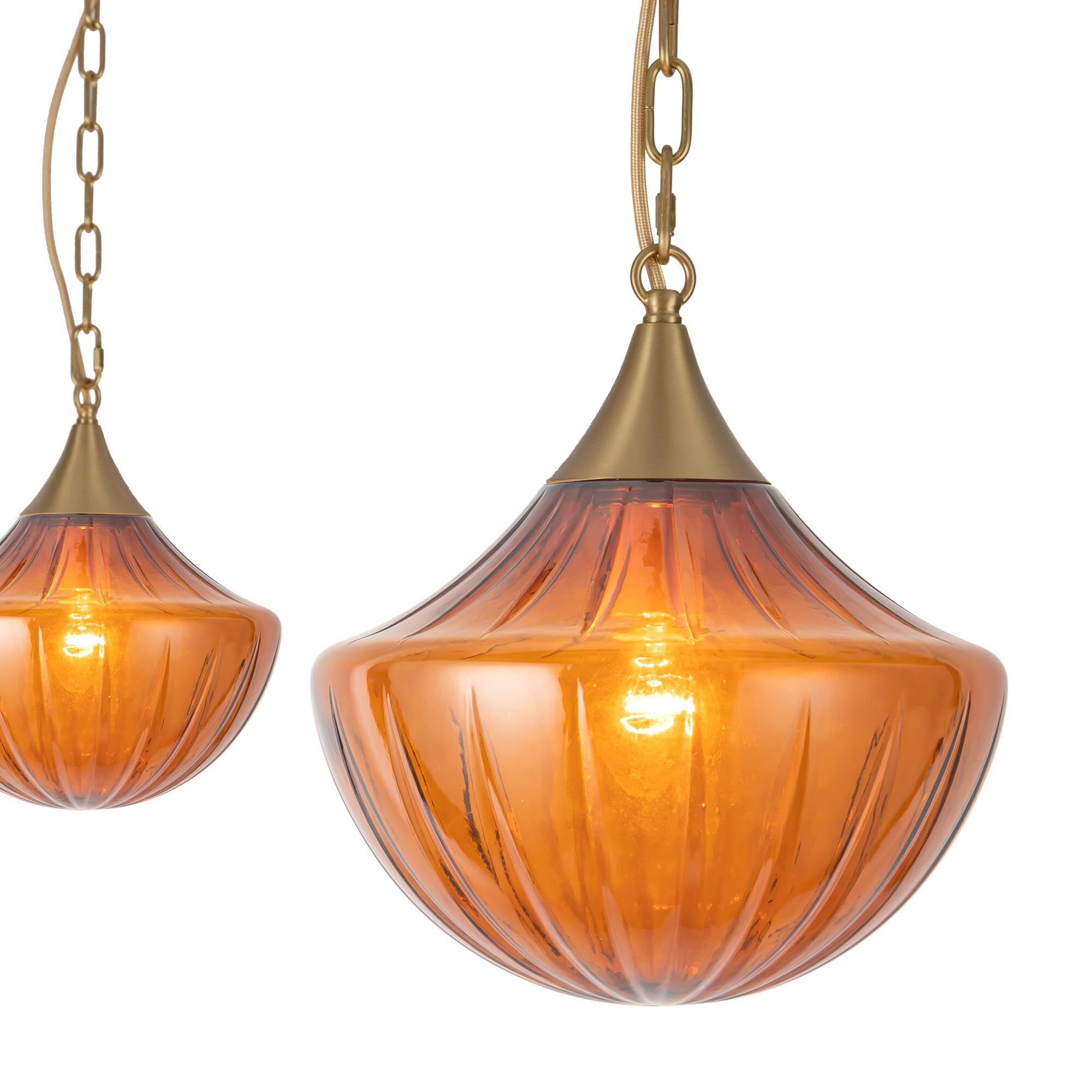 Shown in Brushed Gold finish and Amber Ribbed glass