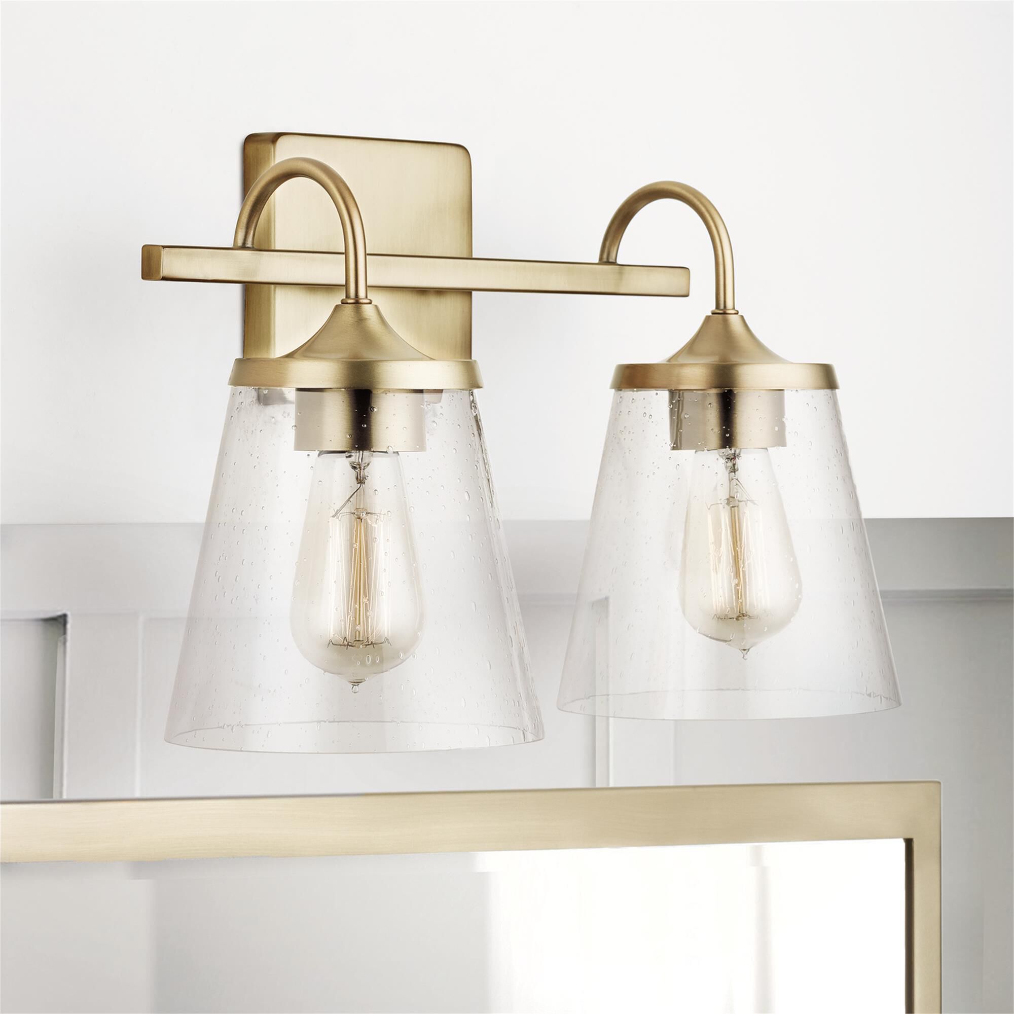 Shown in Aged Brass finish and Clear Seeded glass