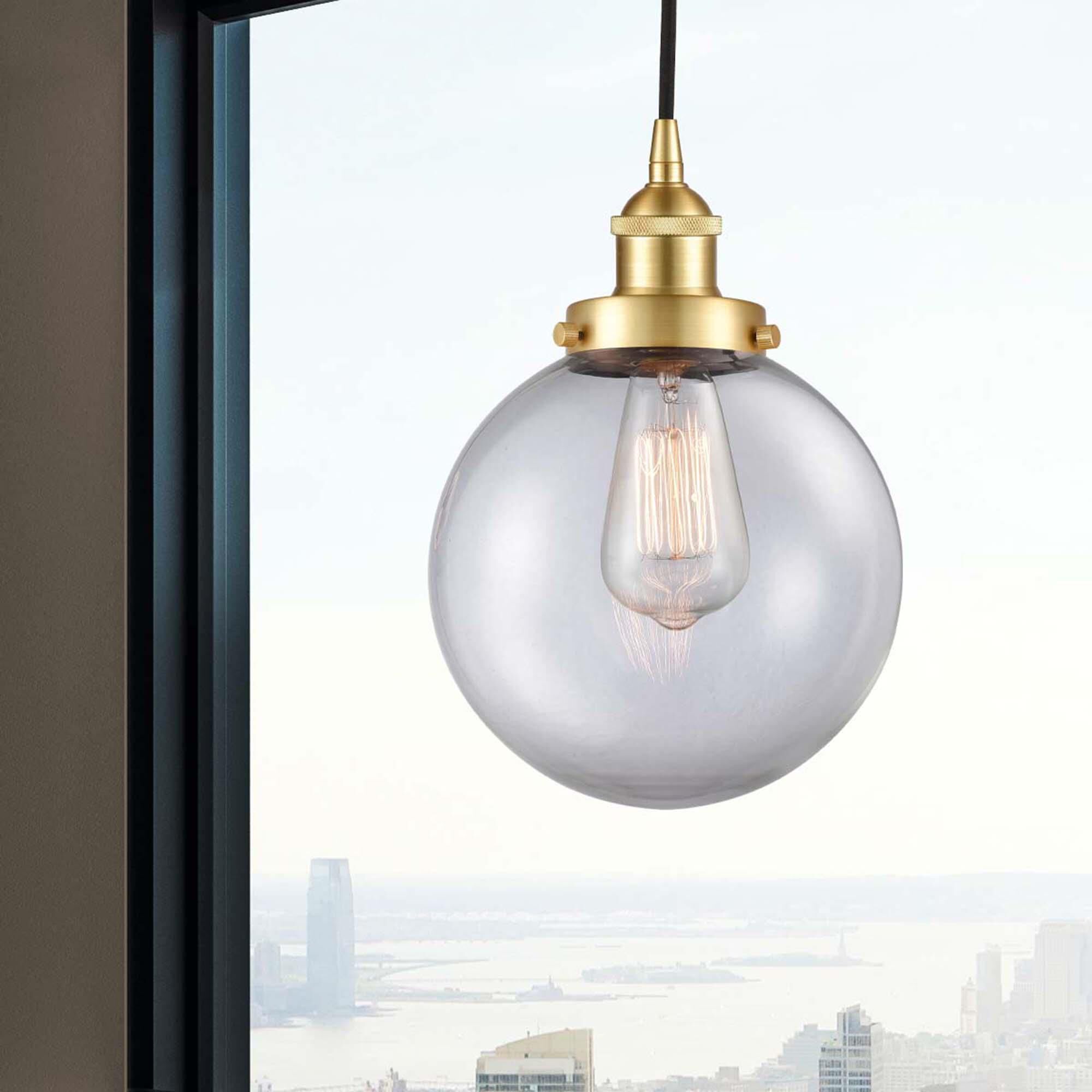 Shown in Satin Gold finish and Clear Beacon glass
