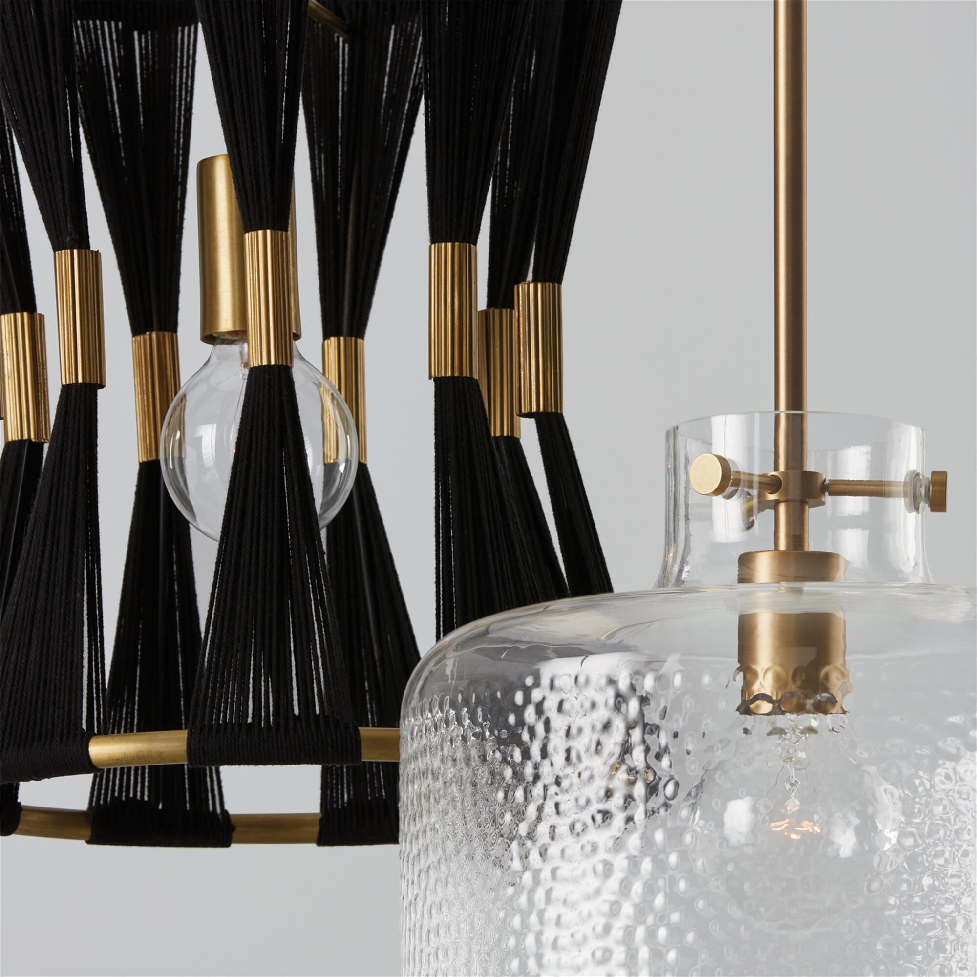 Shown in Aged Brass finish and Clear Pebbled glass